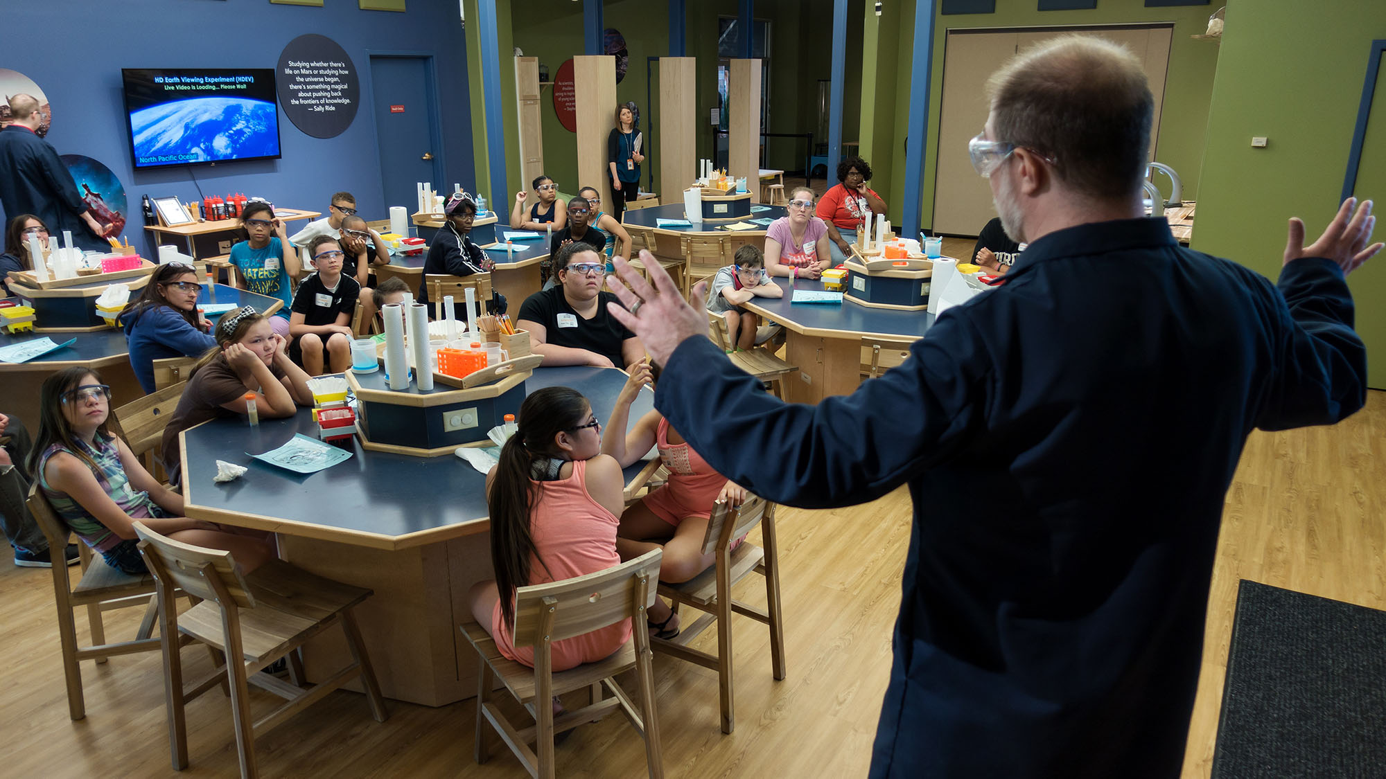 Staff member talking to a room full of students.