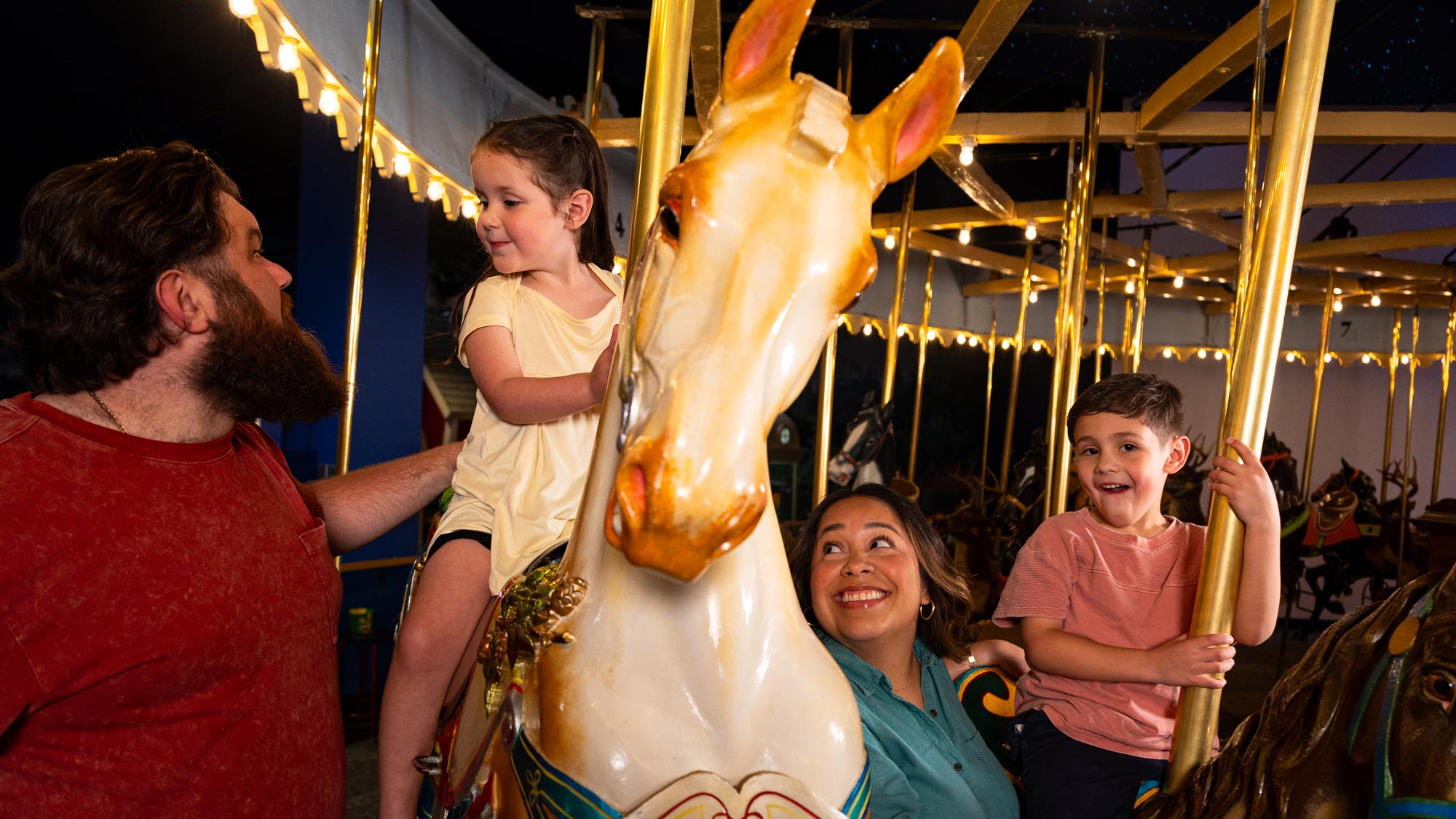 Family riding the Carousel.