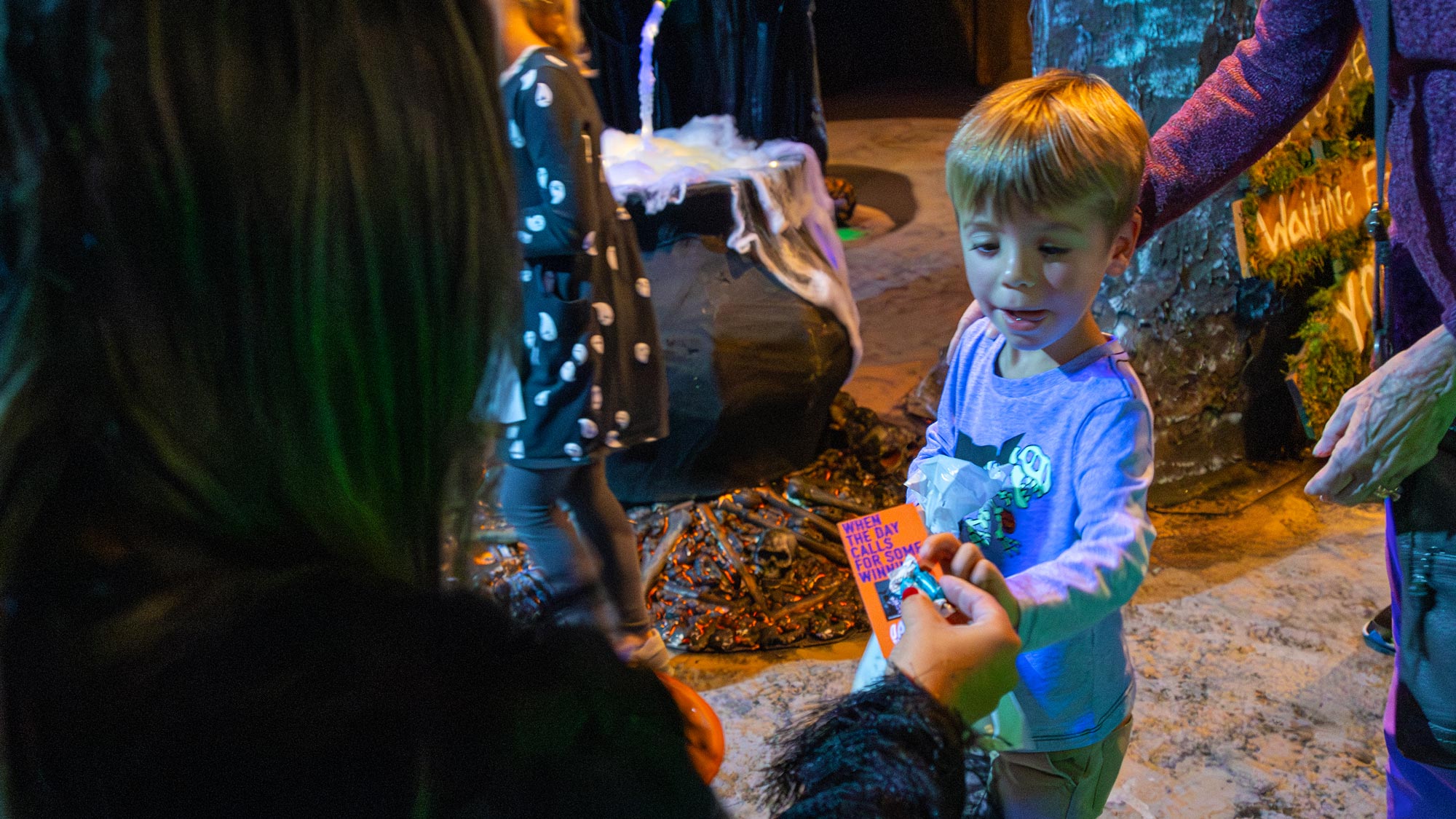 Friendly witch handing out candy in the Haunted House during Friendly Hours.