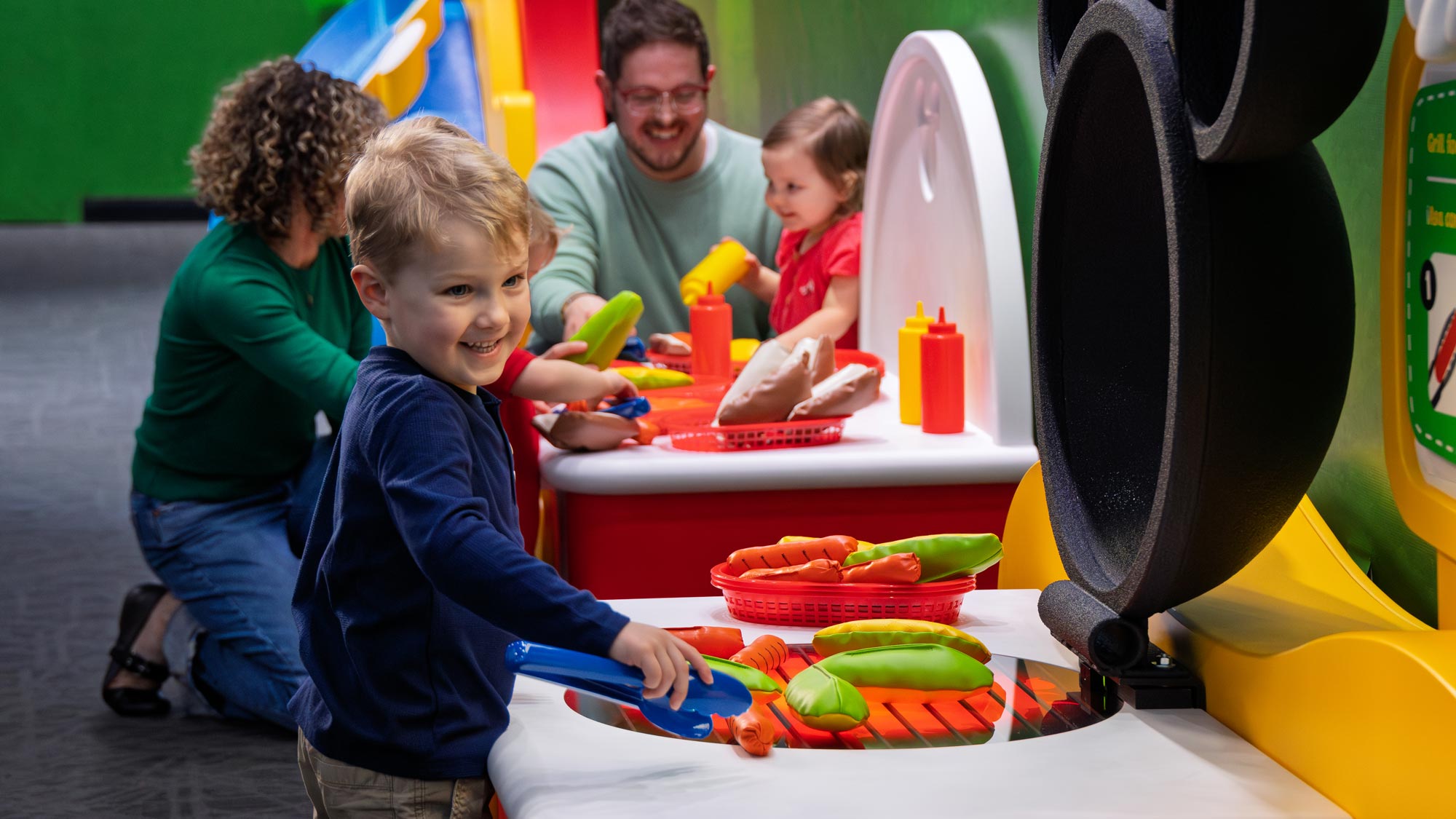 Child grilling pretend play hot dogs.