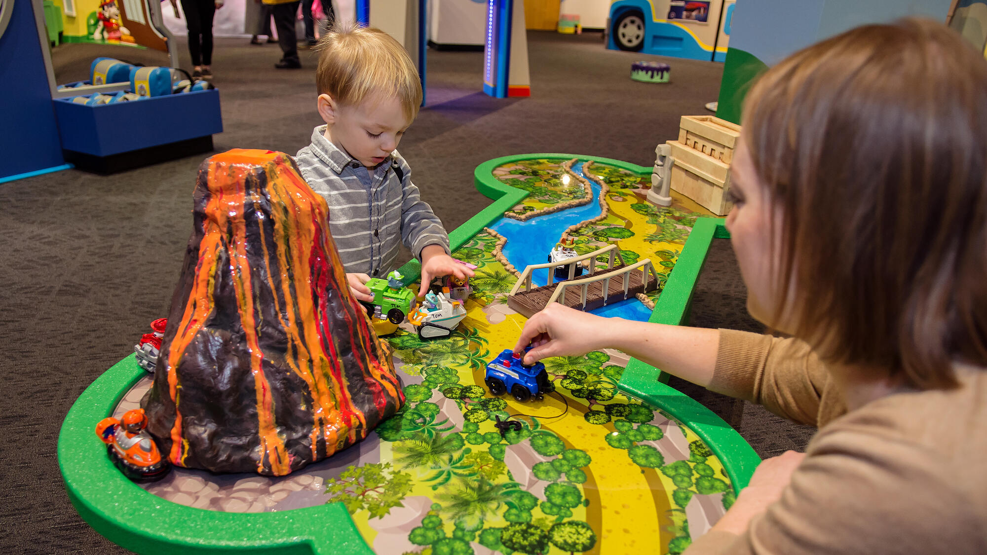 Grown-up and child playing at the Jungle Play Table.