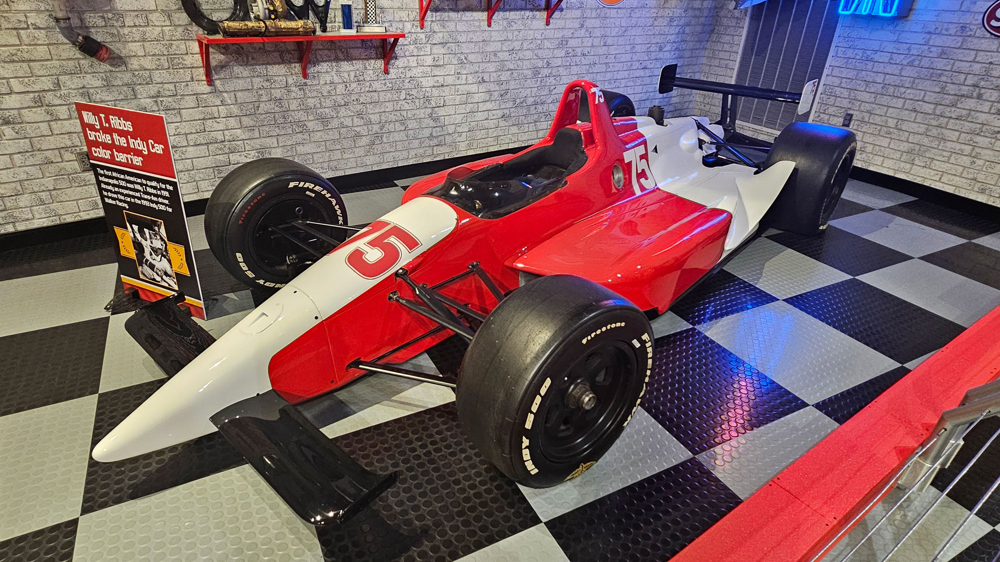 Red and white IndyCar race car that Willy T. Ribbs drove in the Indianapolis 500 in 1993.