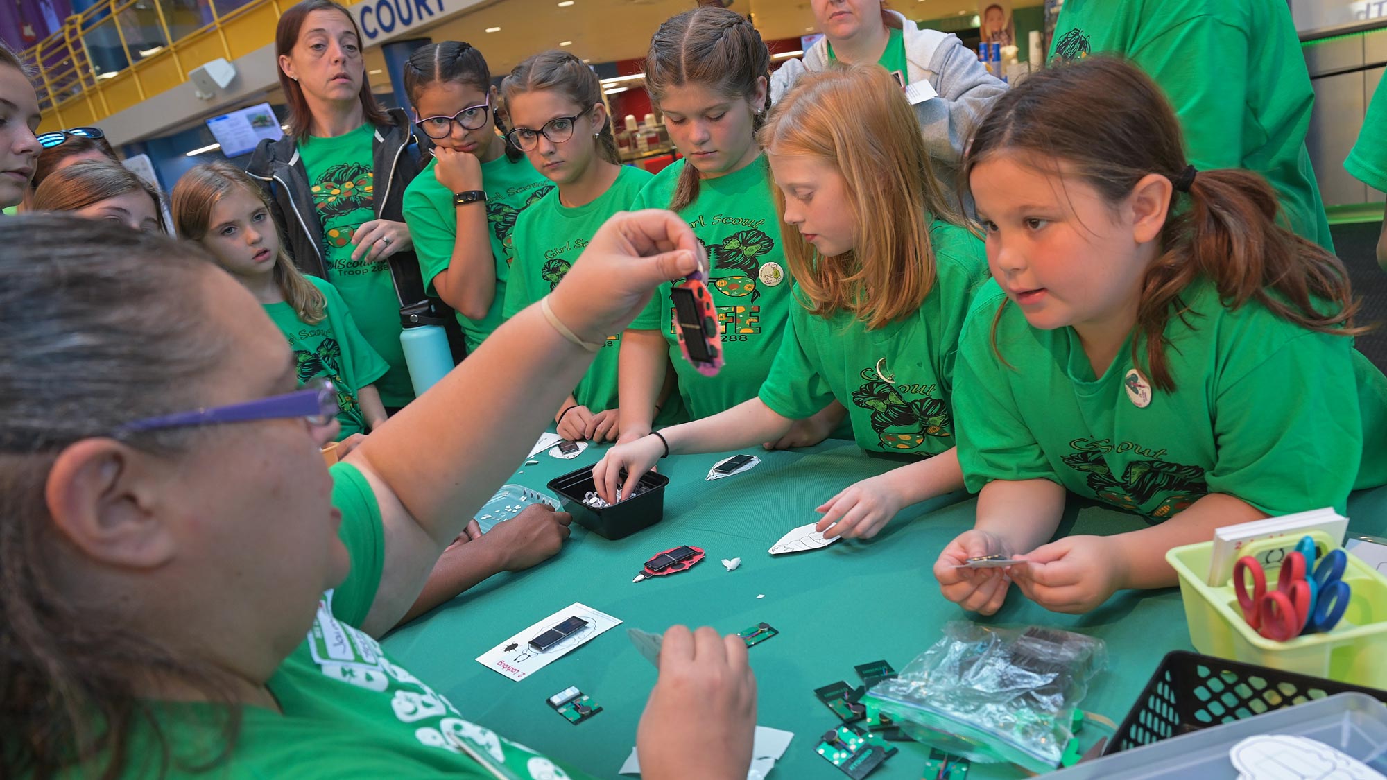 Scientist showing a group of children experiment results.