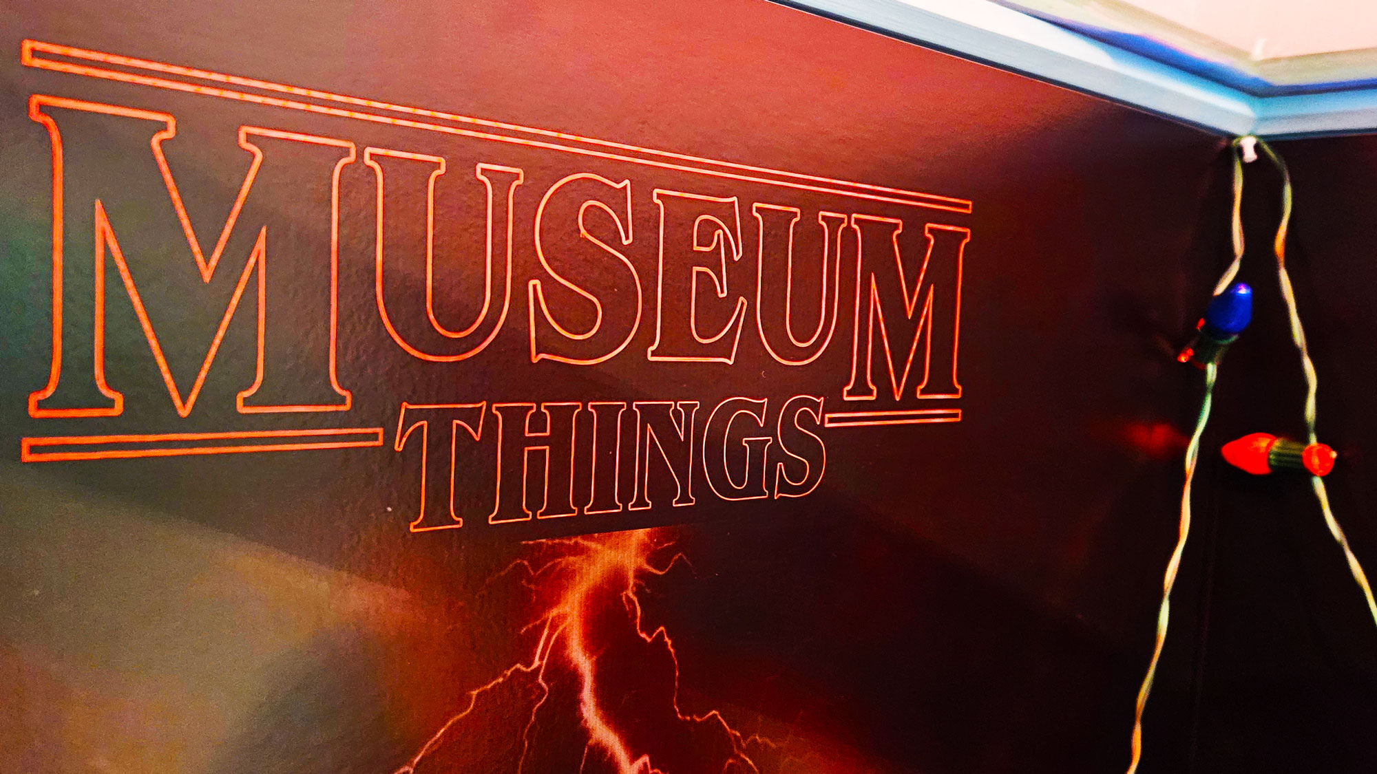 Museum Things sign with string of Christmas lights.