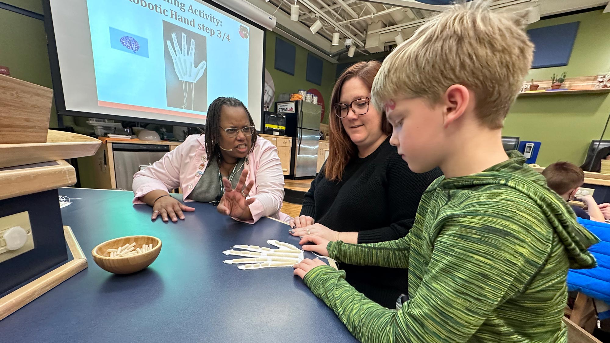 Visiting Scientist Dr. Carlotta Berry providing individualized instruction with child and grown-up.