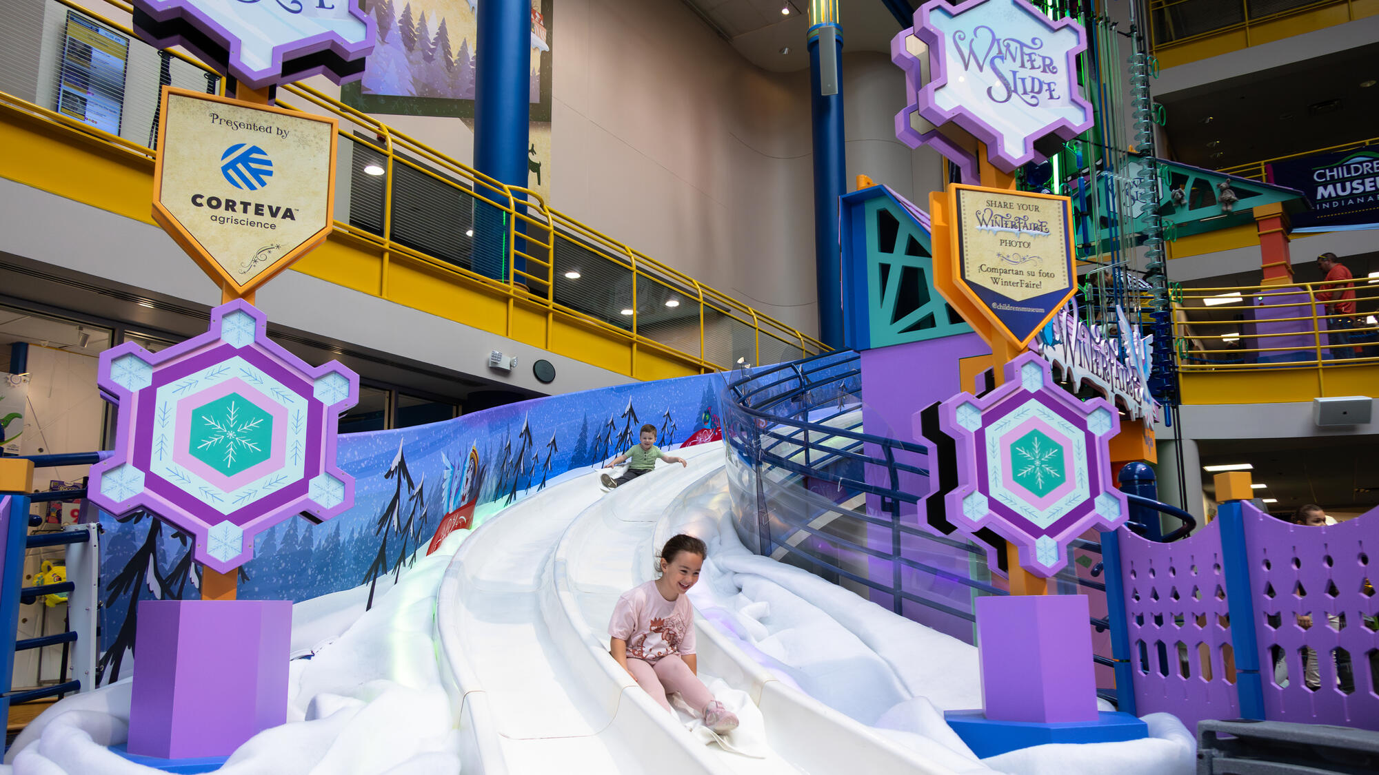 Two children sliding down WinterSlide.