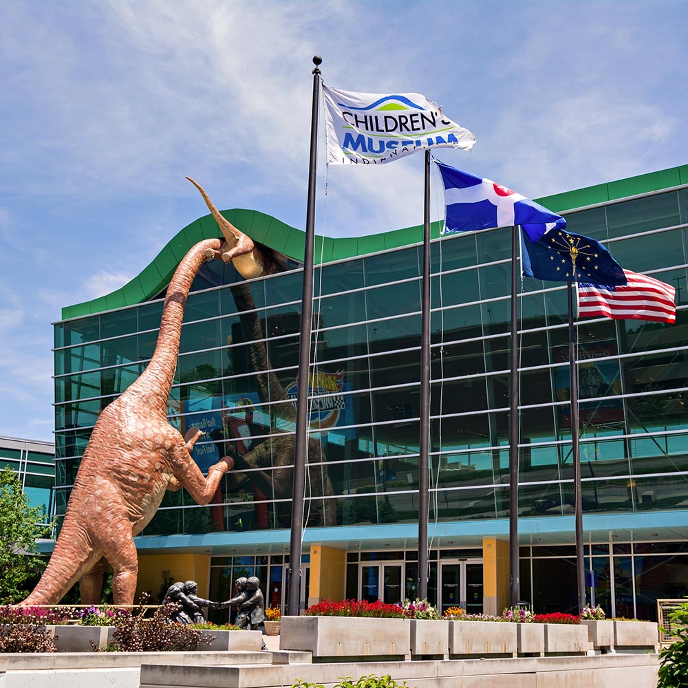 Exterior photo of the museum building with flags waving