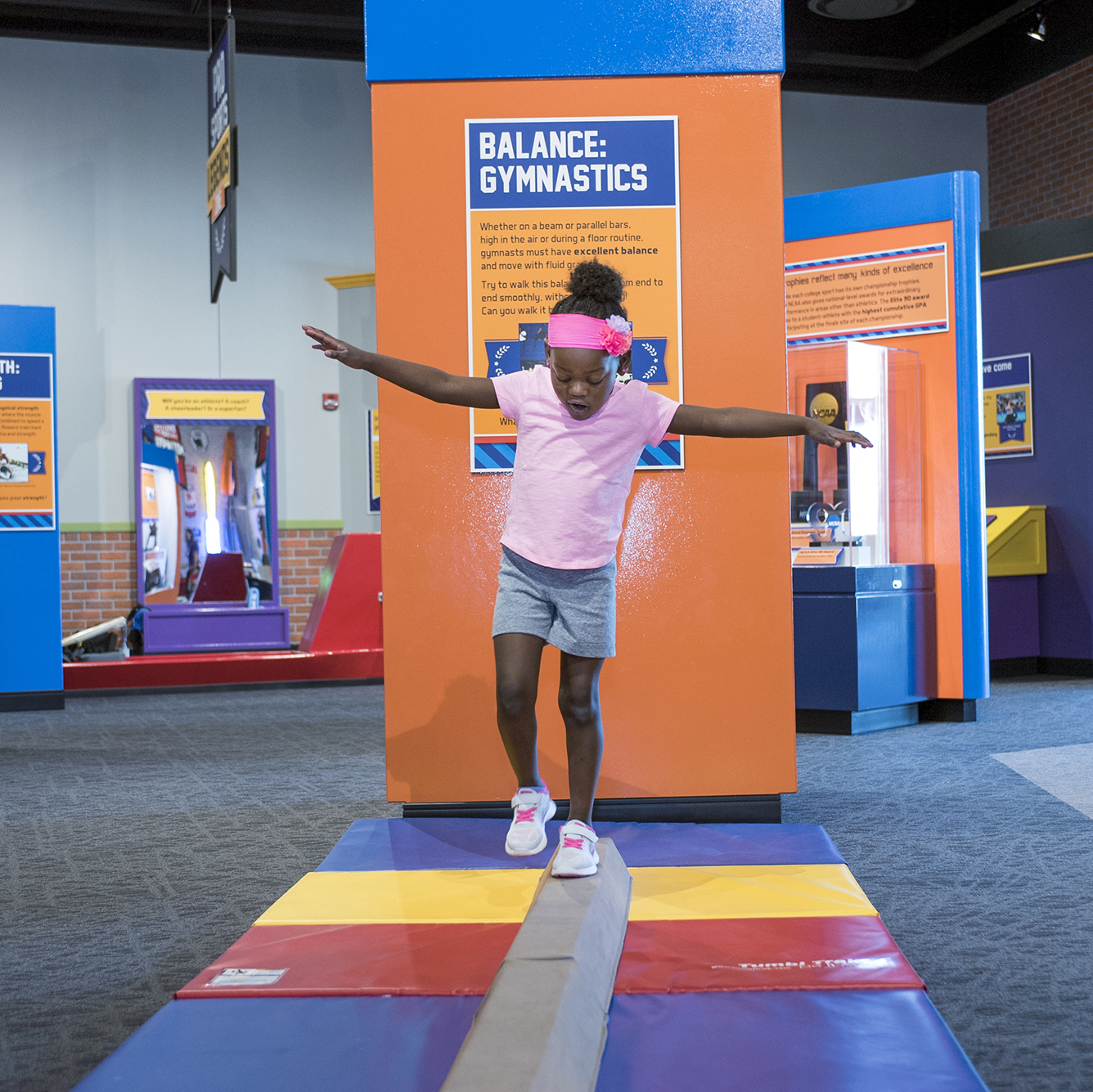 Child walking on a balance beam.