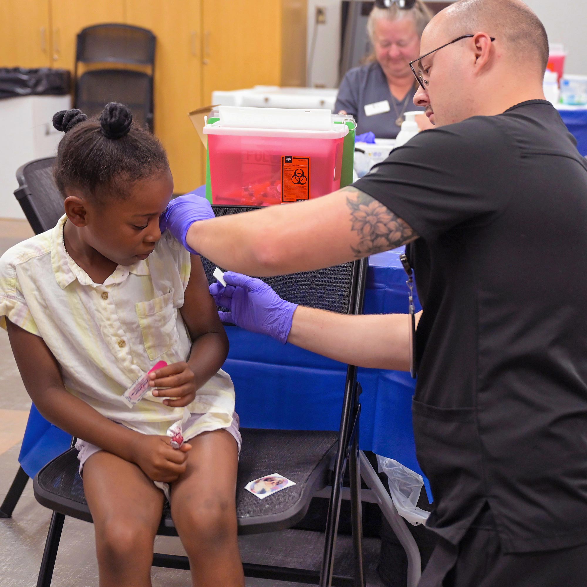 Child receiving vaccine in arm.