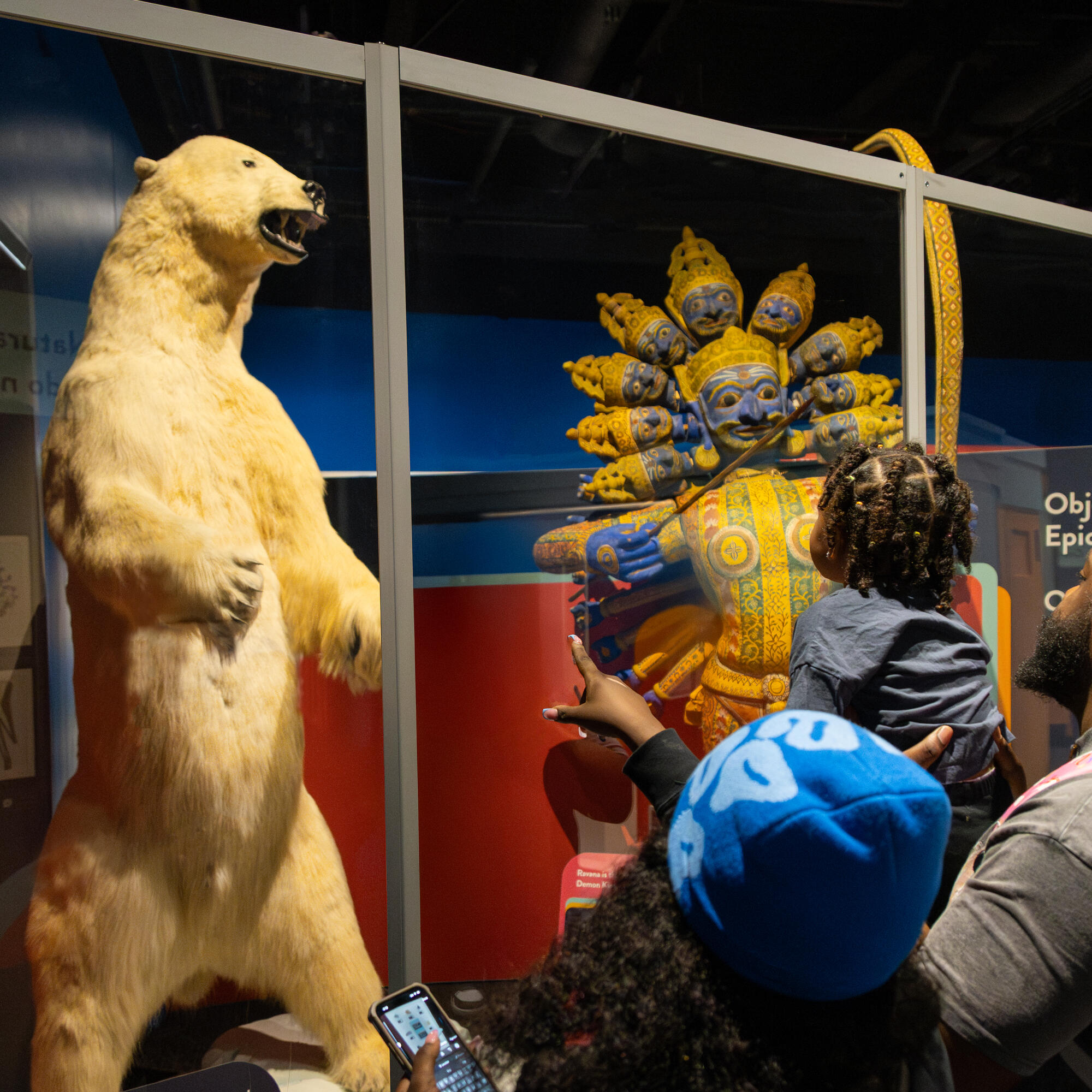 Family looking at Martimus the polar bear on display in the exhibit.