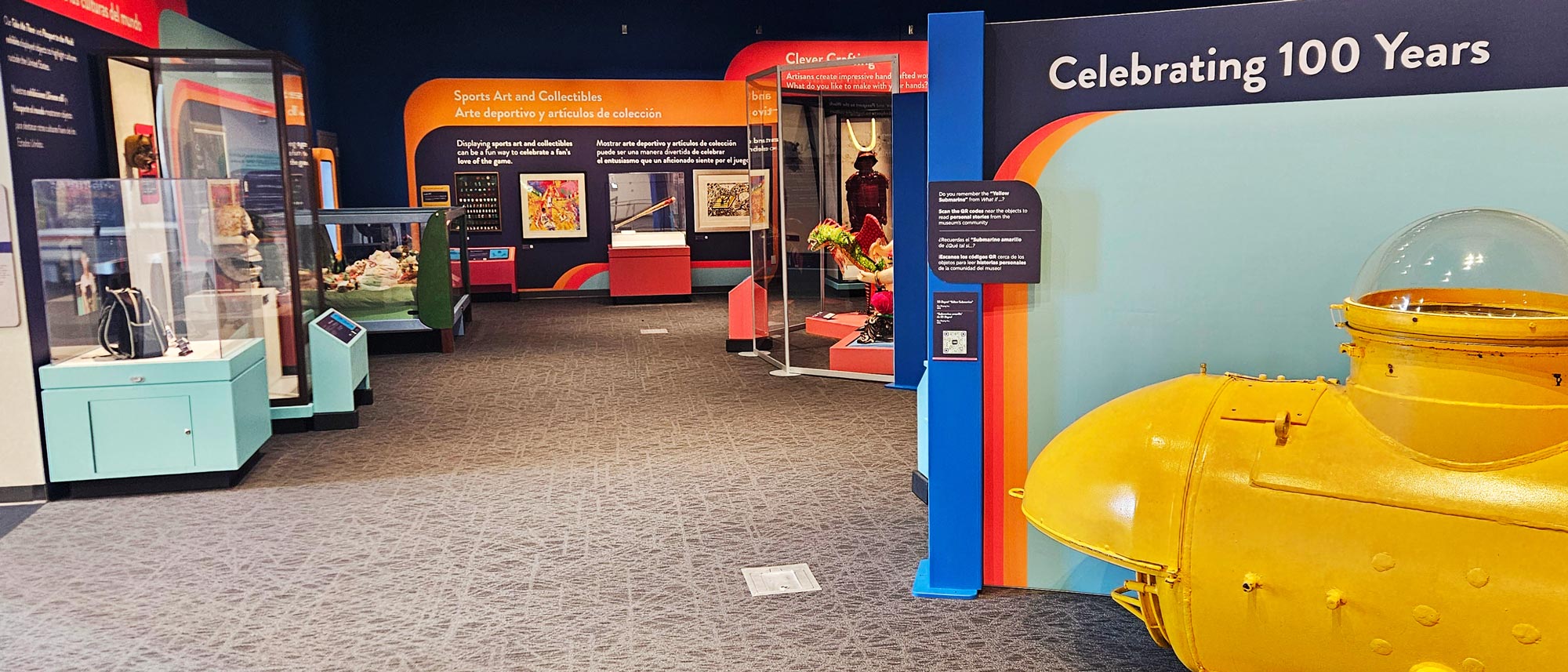 Yellow submarine, samurai armor, and signed baseball bat seen from the entrance to Memories, Wonders, and Dreams: Stories from 100 Years exhibit.