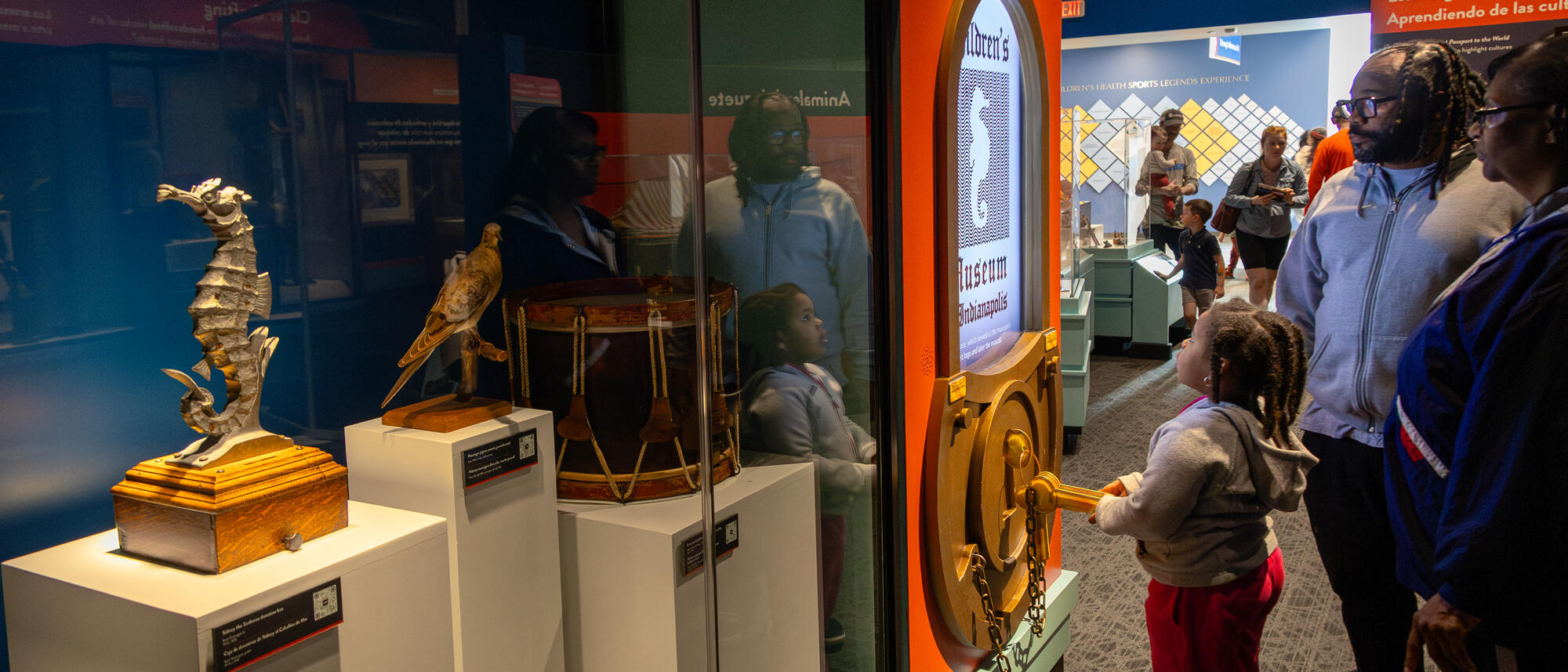 Yellow submarine, samurai armor, and signed baseball bat seen from the entrance to Memories, Wonders, and Dreams: Stories from 100 Years exhibit.