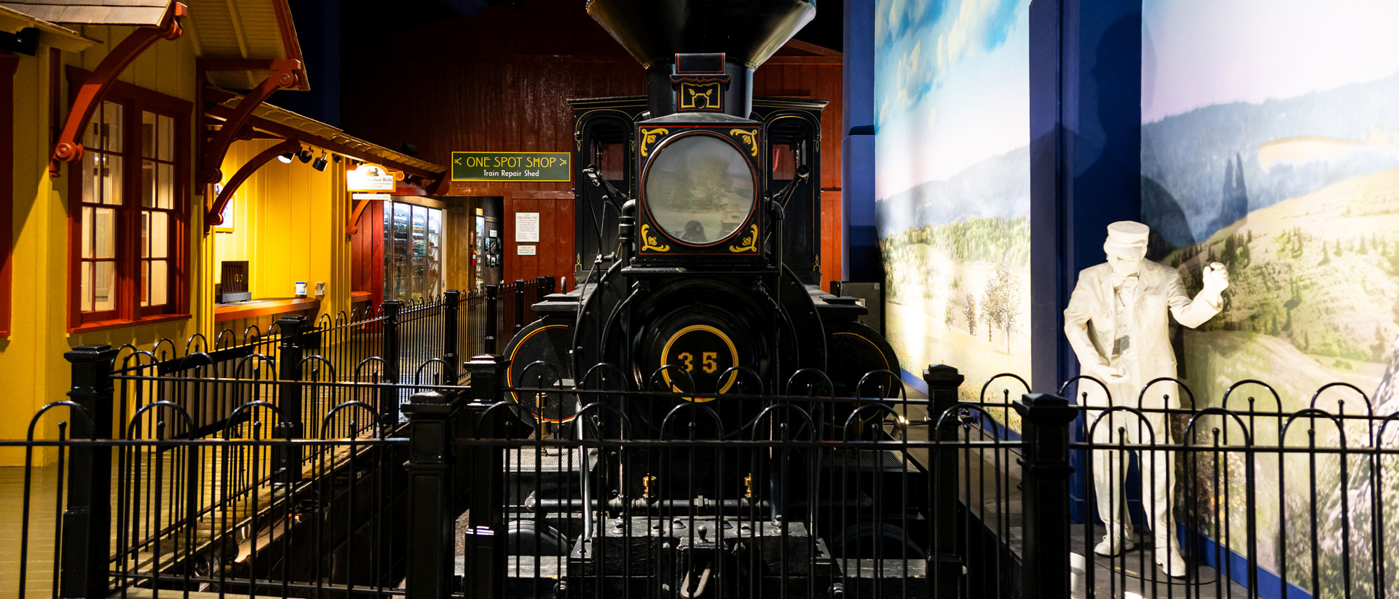 Families looking at the Reuben Wells train inside the exhibit.