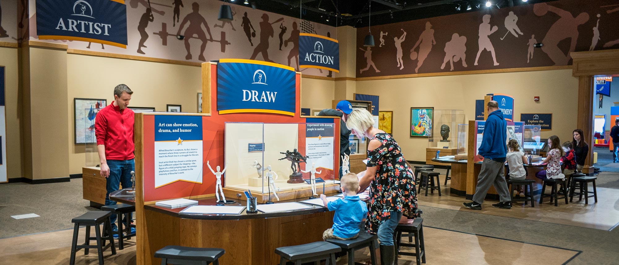 People making sports-inspired art inside the exhibit.