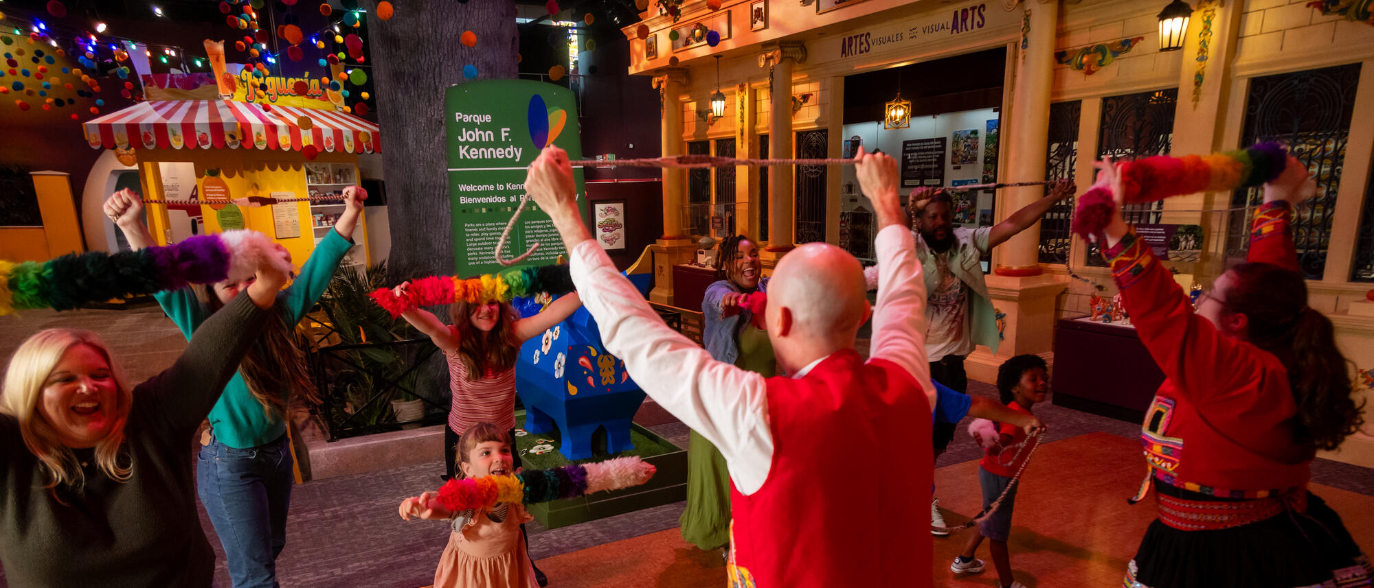 Families dancing in Take Me There: Peru exhibit.