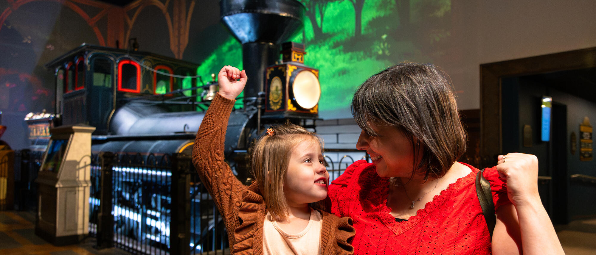 Families looking at the Reuben Wells train inside the exhibit.