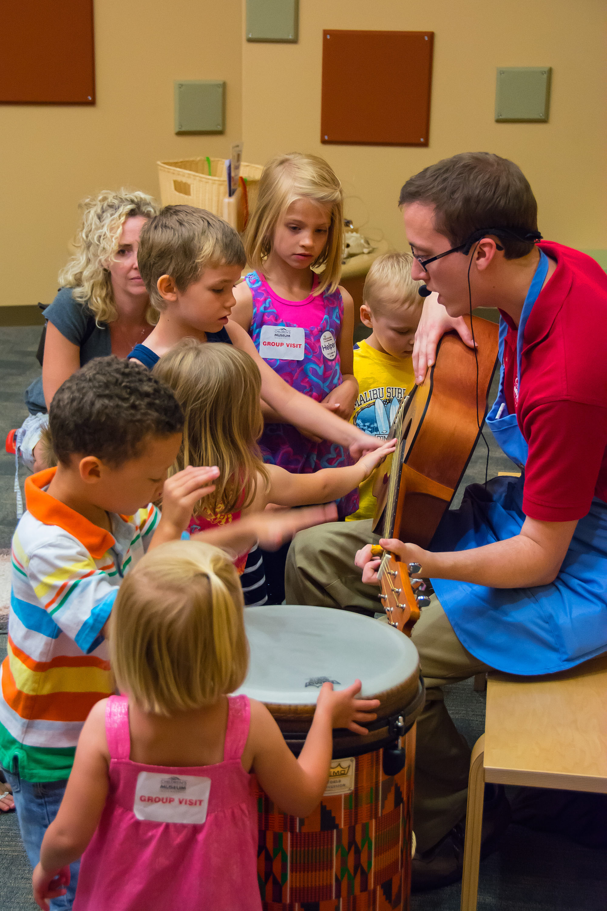 Children touching guitar.