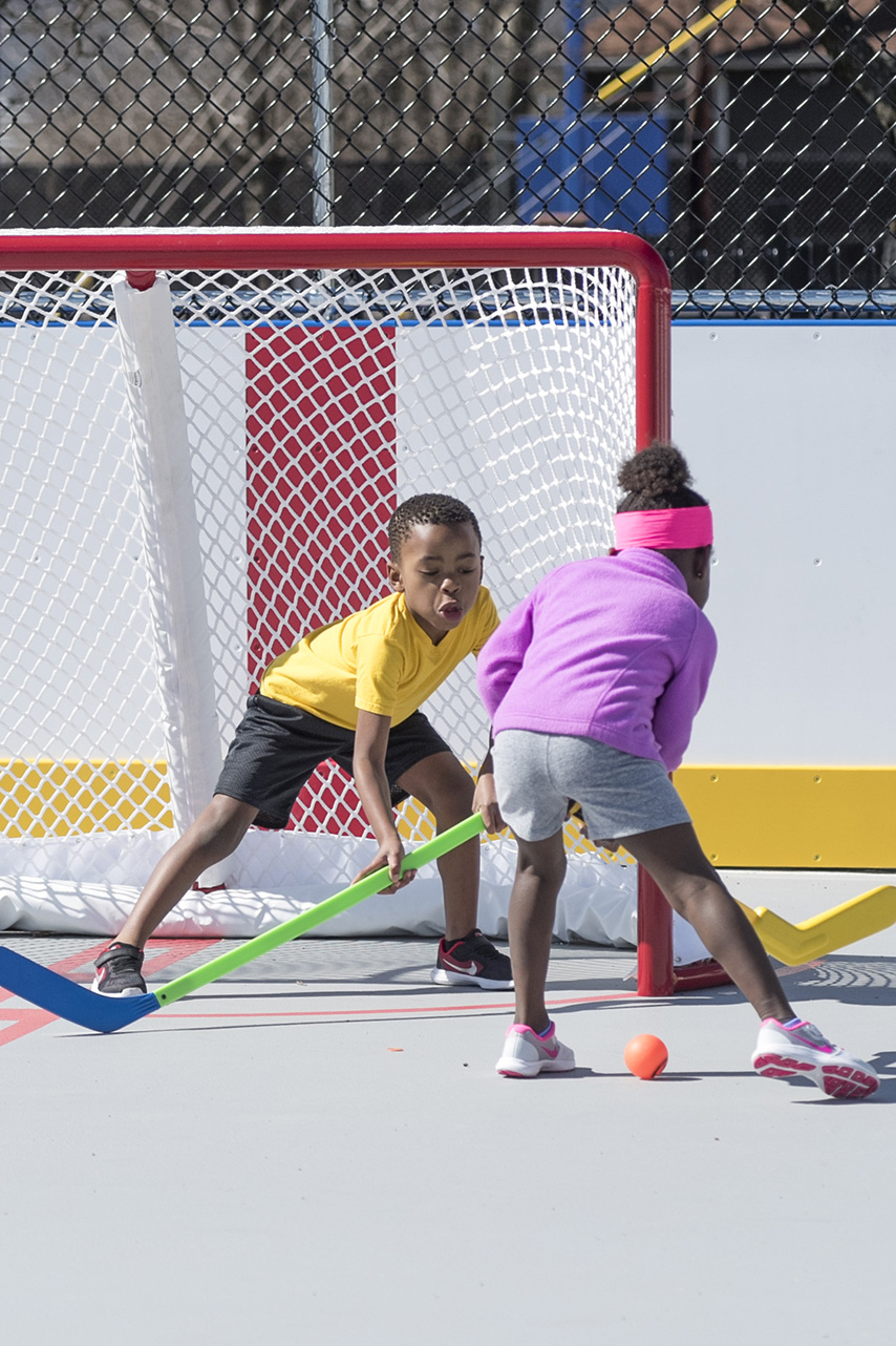 Child defending a slapshot.