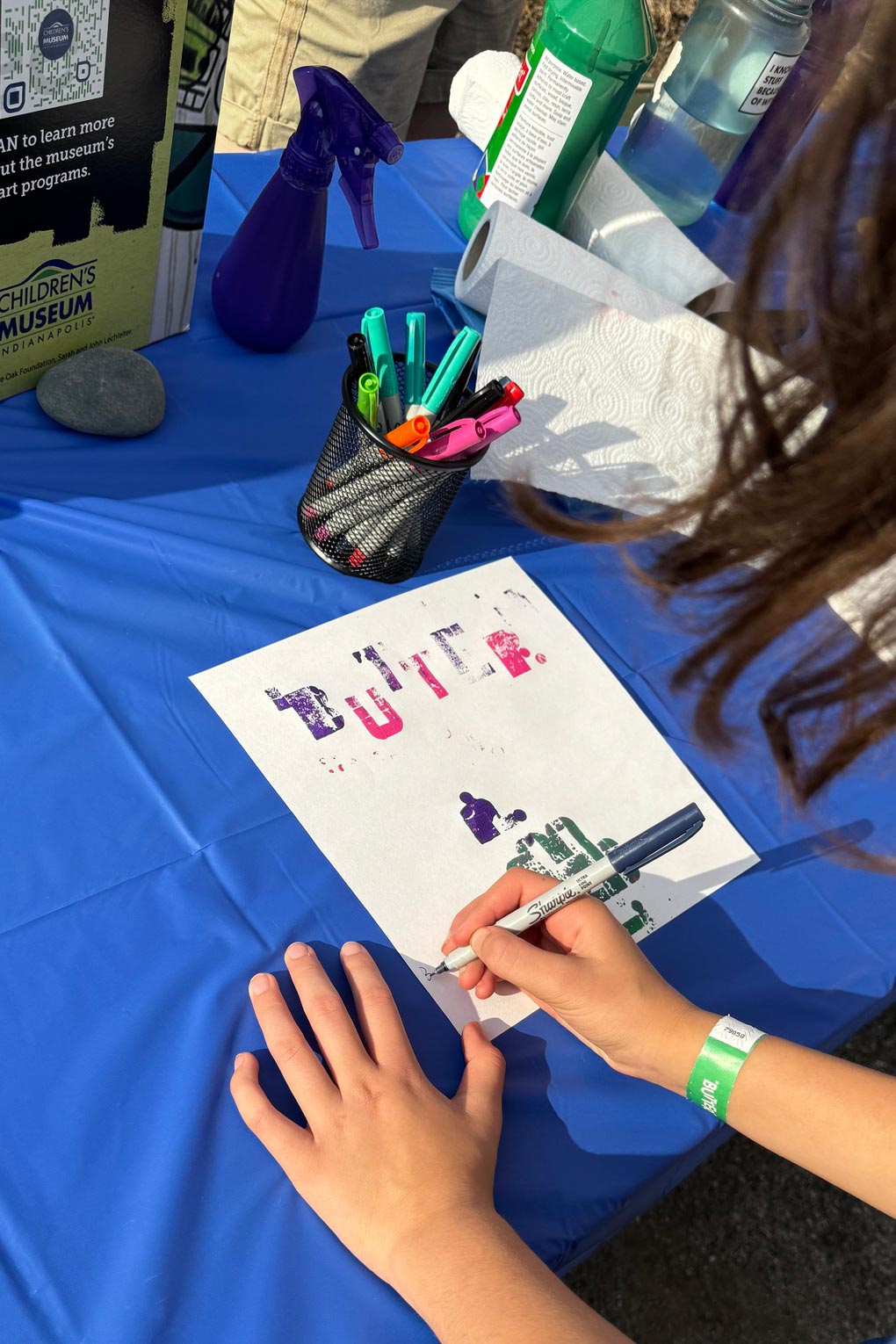 Person using markers to design a piece of art.