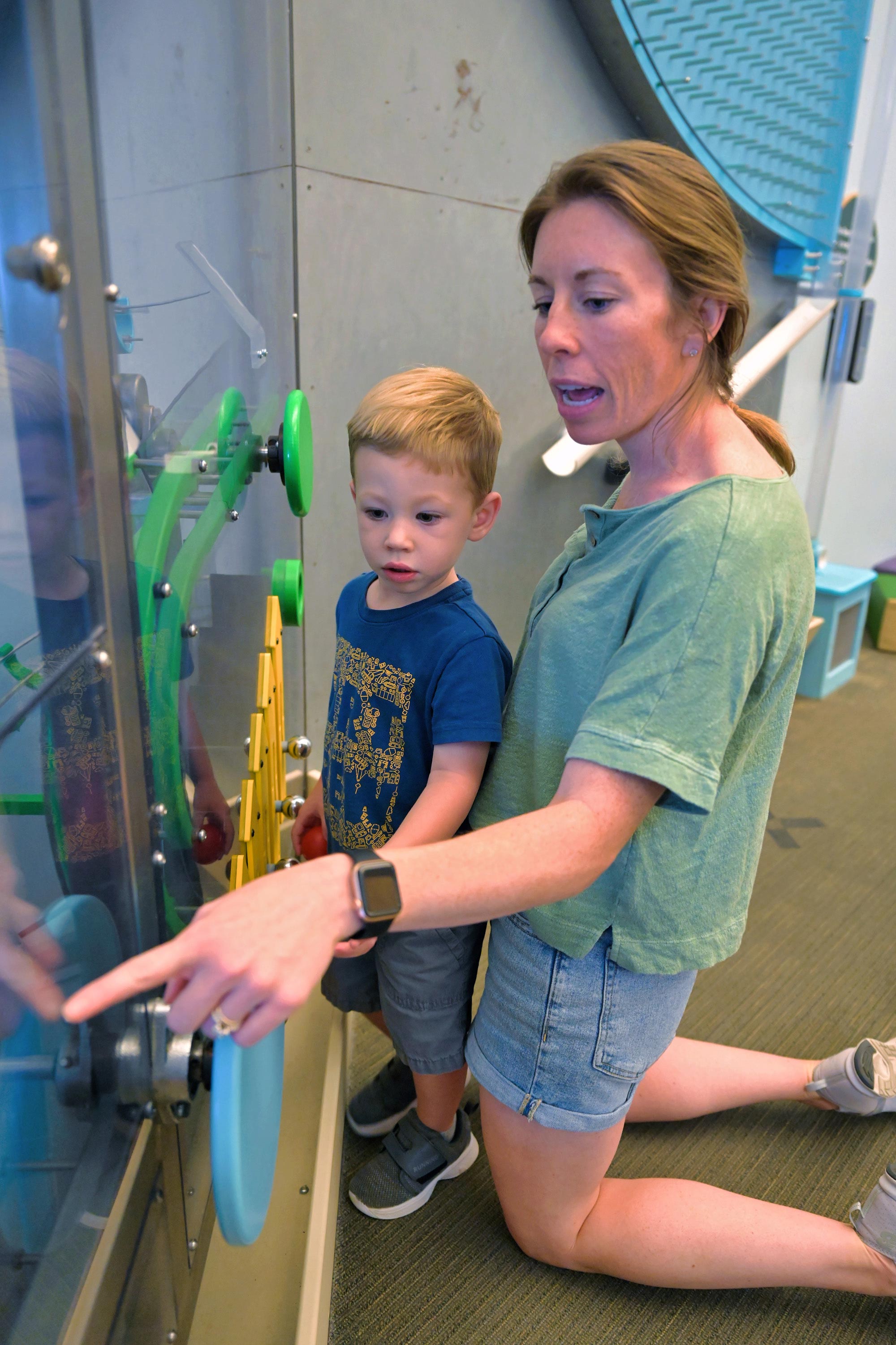 Grown-up and child looking at The Reaction Contraption