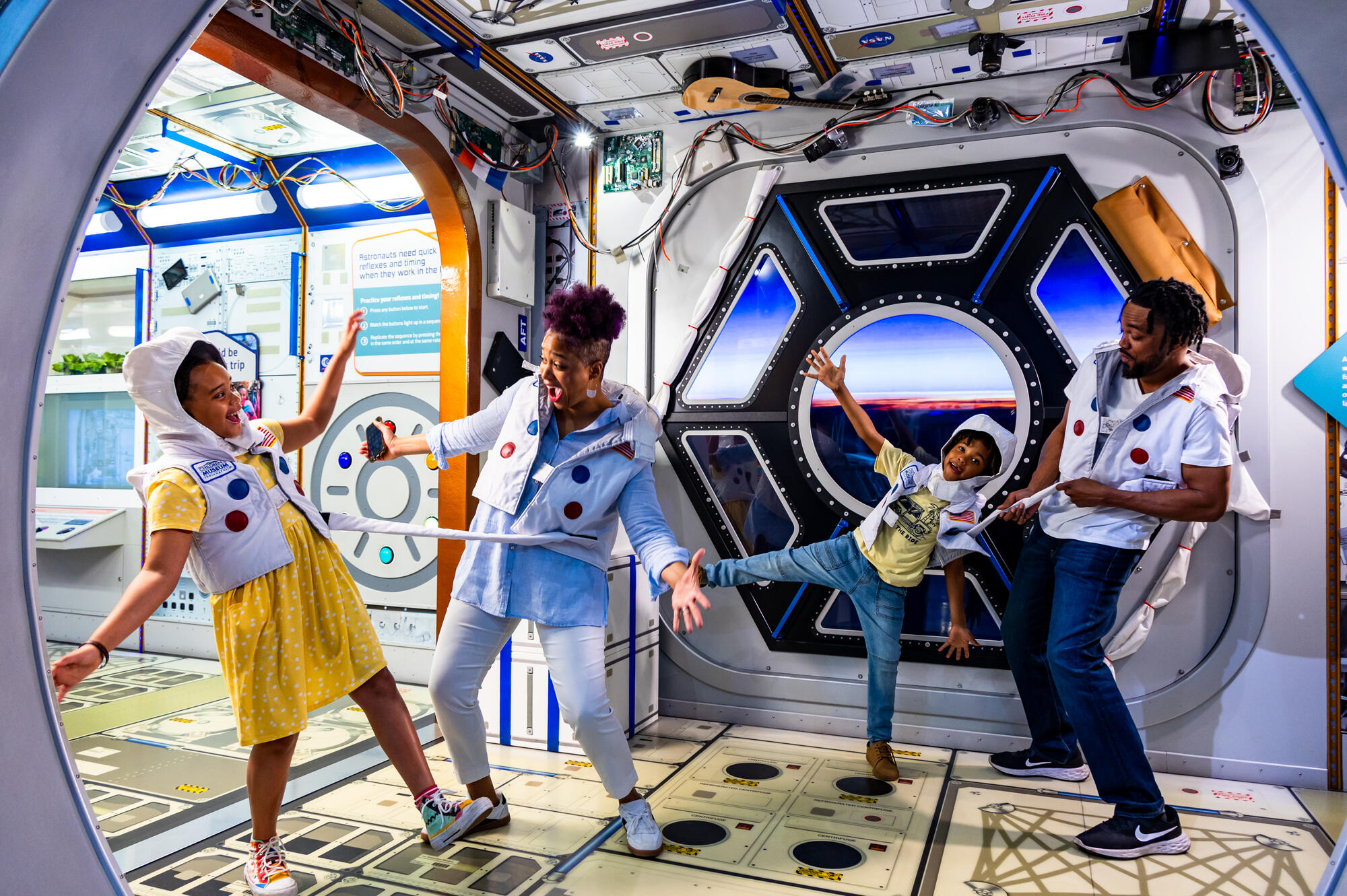 Family wearing astronaut costumes in the Beyond Spaceship Earth exhibit.
