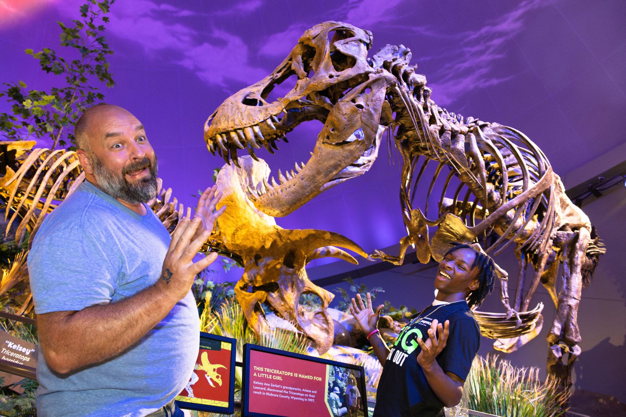 Big and Little acting scared in front of a Tyrannosaurus rex fossil inside Dinosphere.