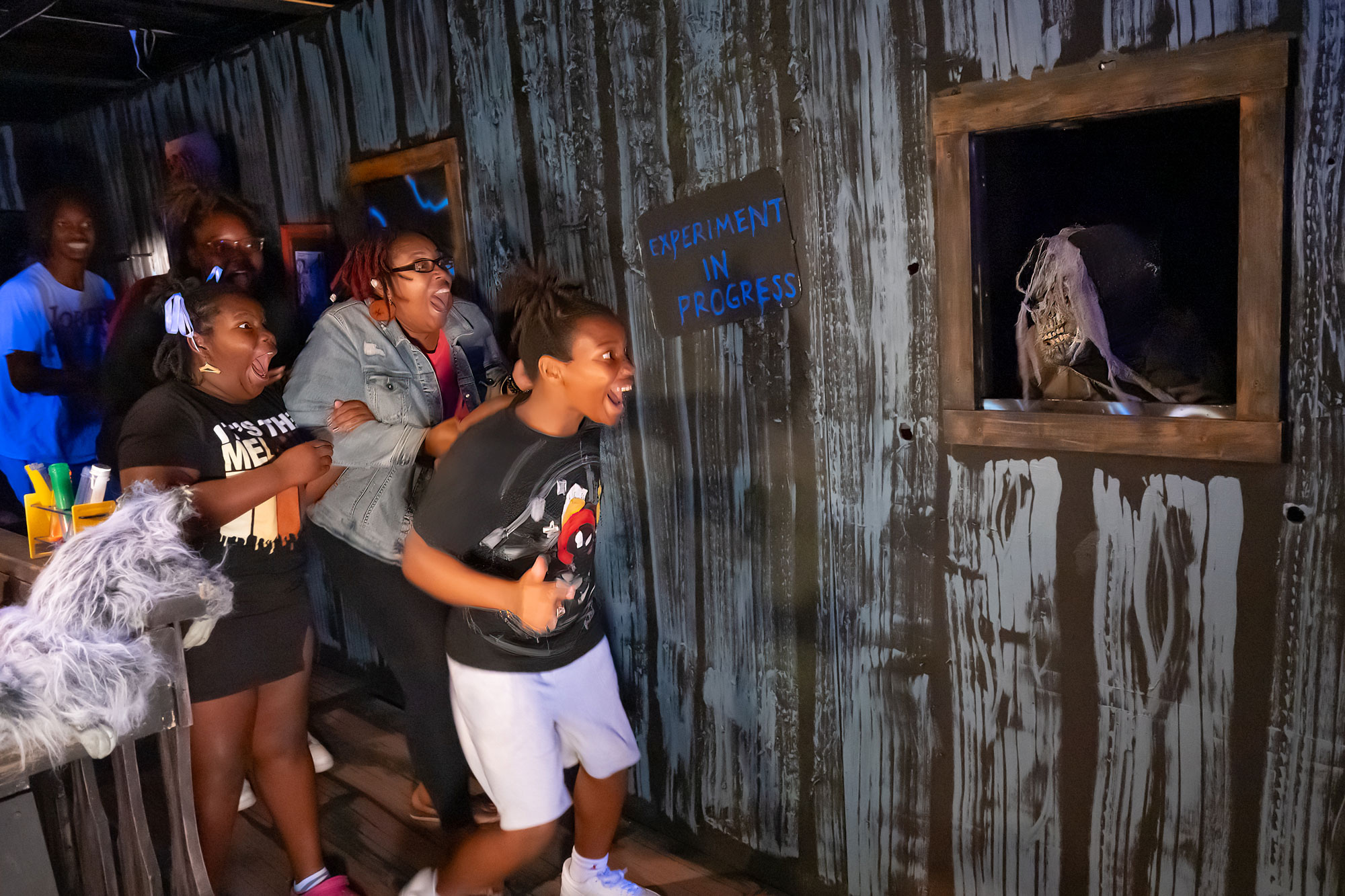 Family screaming at Haunted House display.