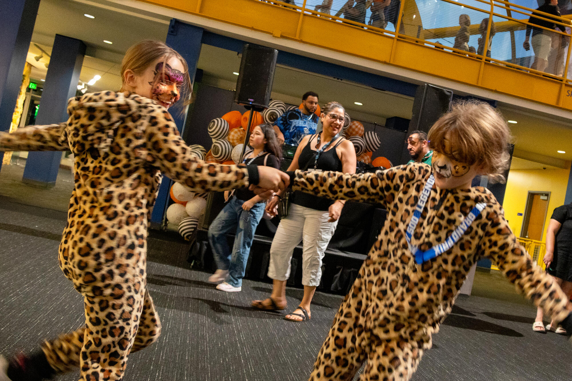 Children wearing leopard costumes dancing.