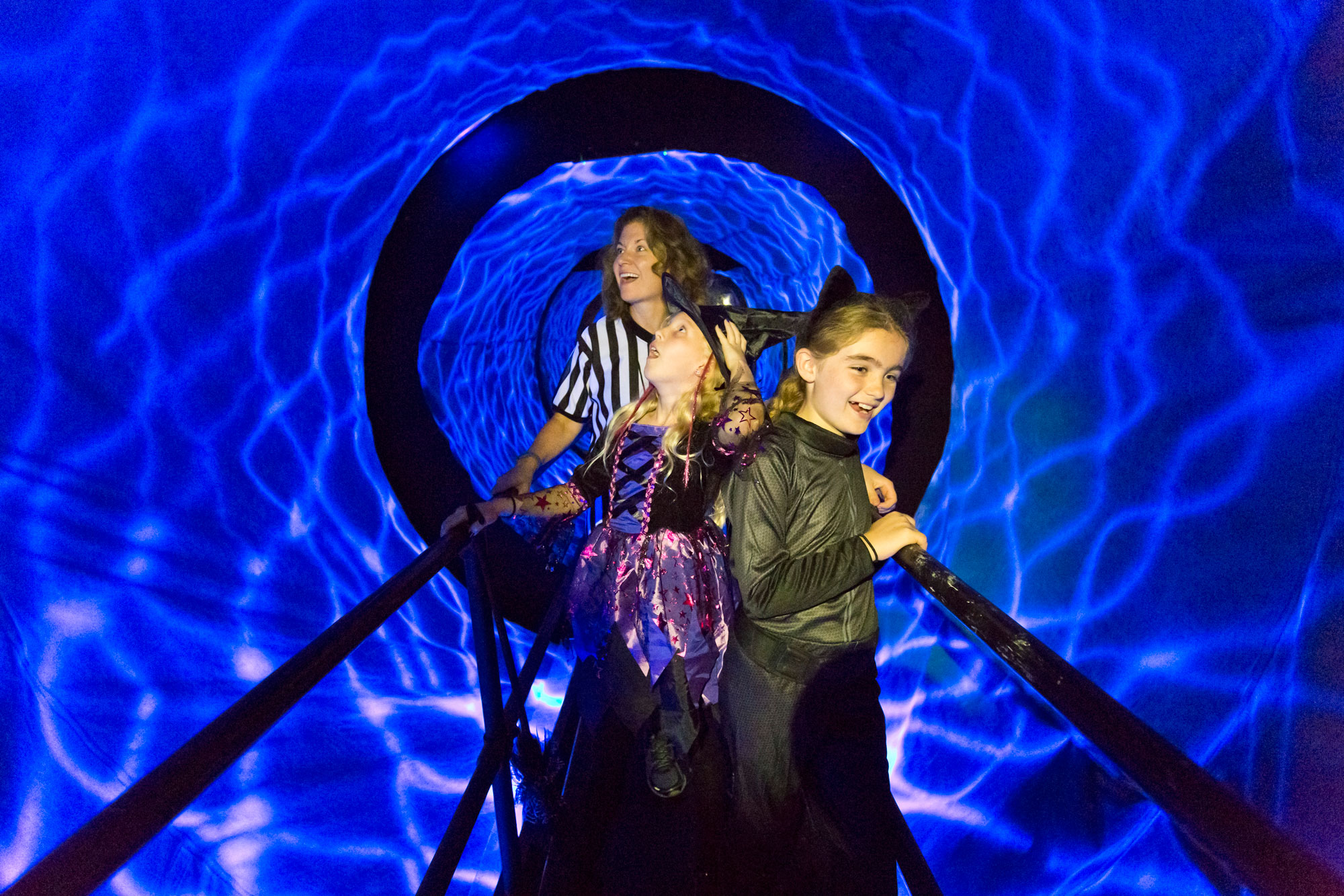 Family walking through dizzying tunnel. 