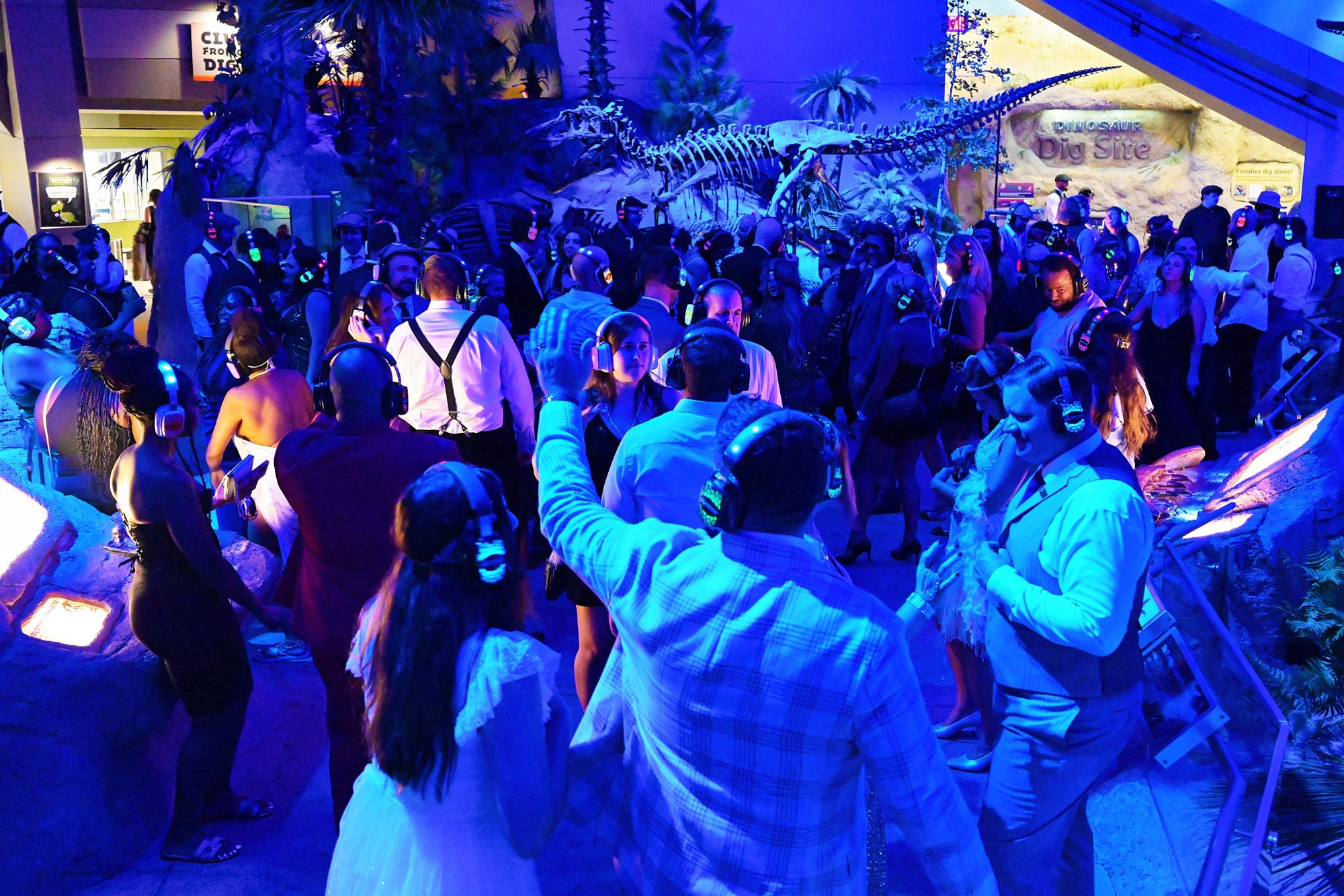 People dancing in the Dinosphere exhibit.