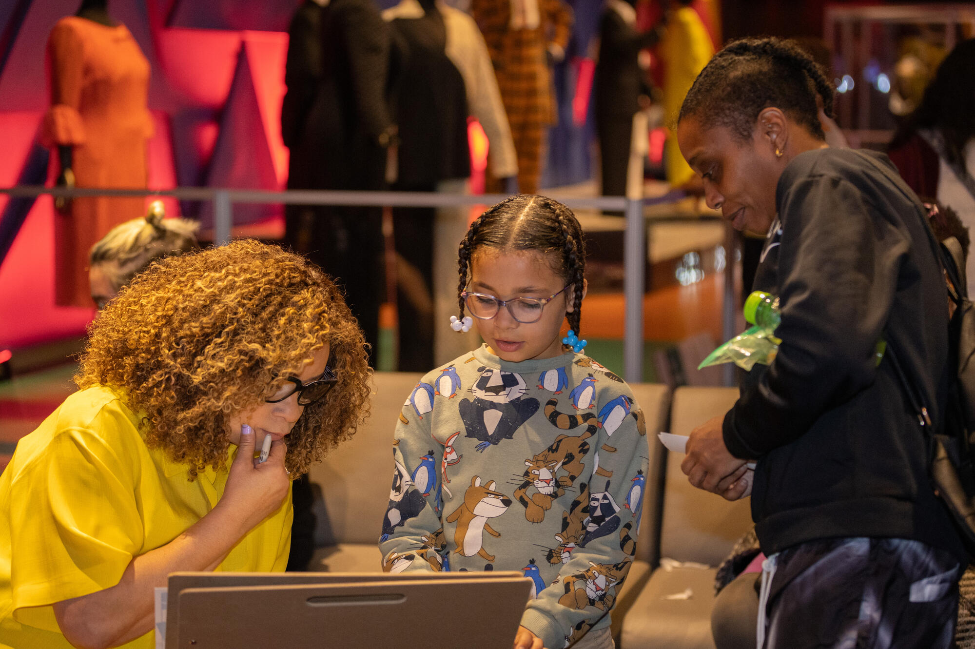 Ruth E. Carter with a family during her opening day visit to The Children's Museum.