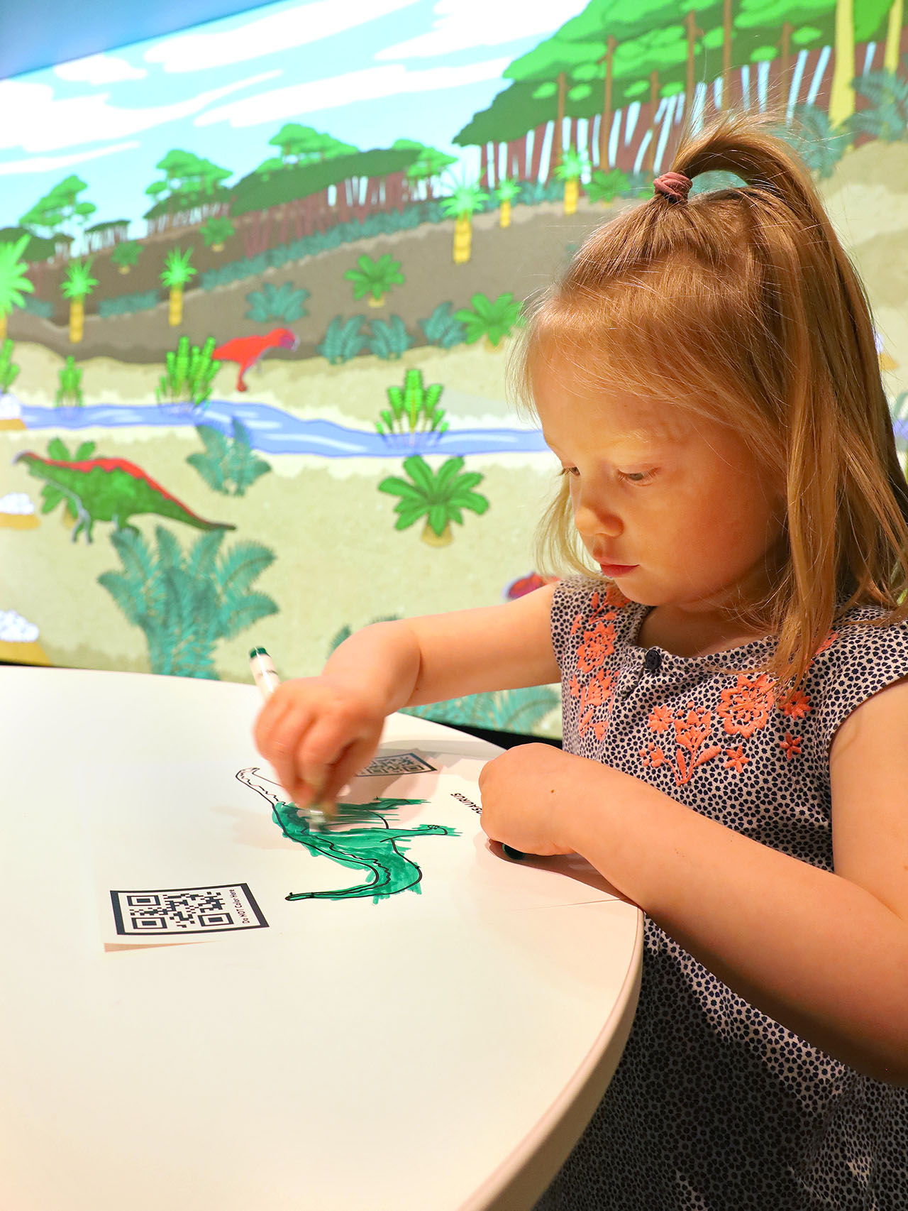 Child coloring dinosaur.