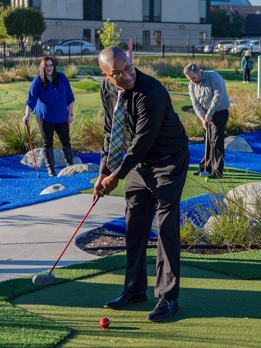 Grown-up putting a golf ball.