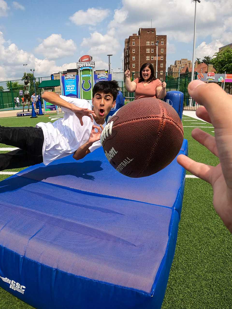 Child diving to catch a football.