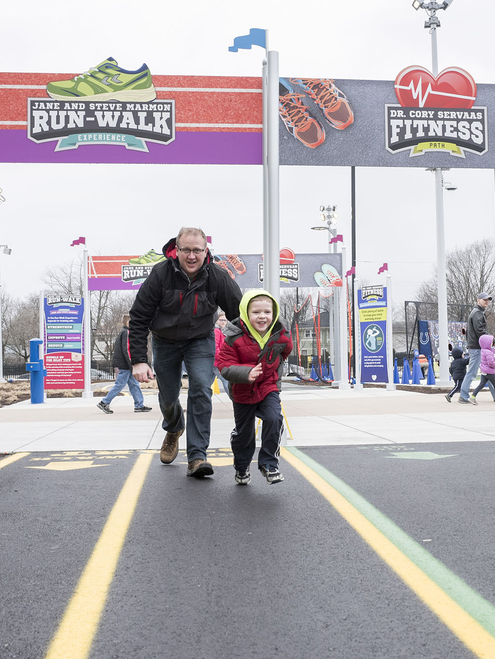 Grown-up and child running.