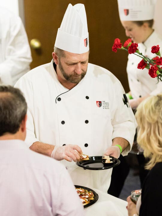 People serving food.