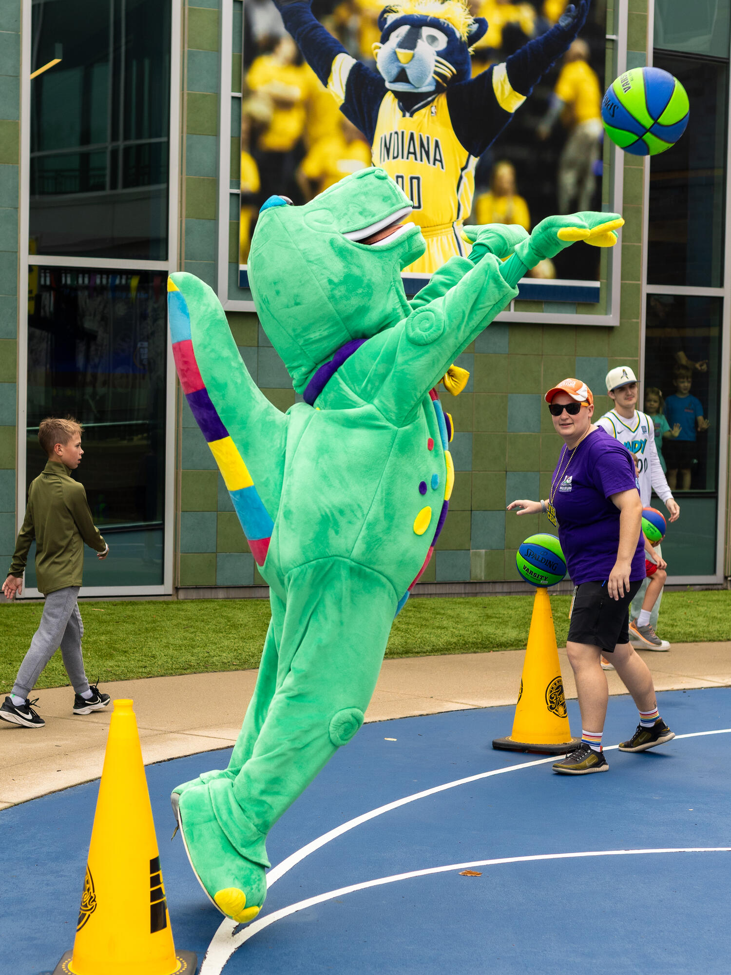 Rex shooting a basketball in the sports experience.