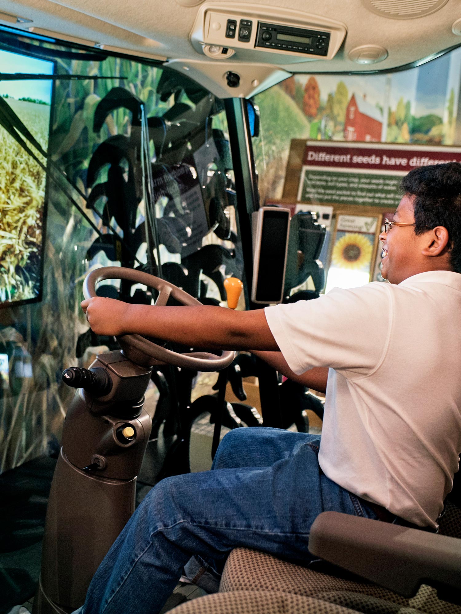 Child driving interactive virtual tractor.