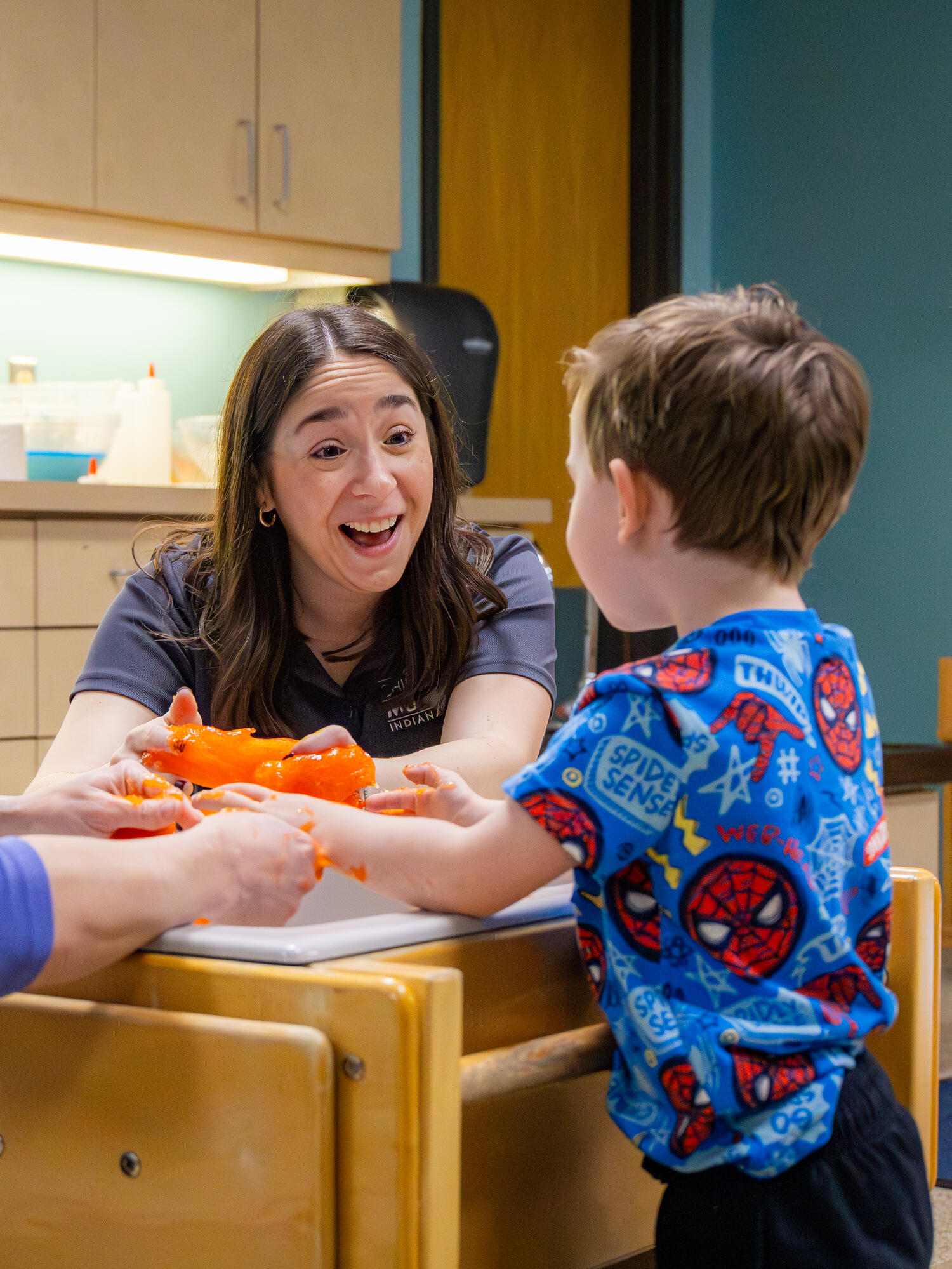 Staff member smiling at a child.