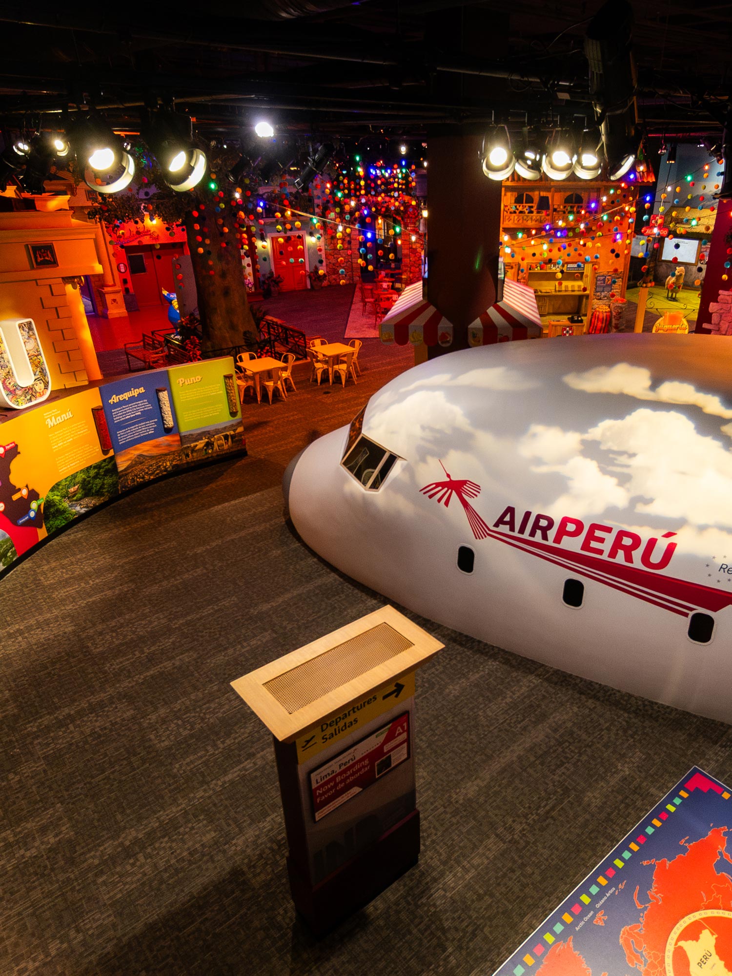 Entrance to the exhibit with a large airplane and colorful lights.