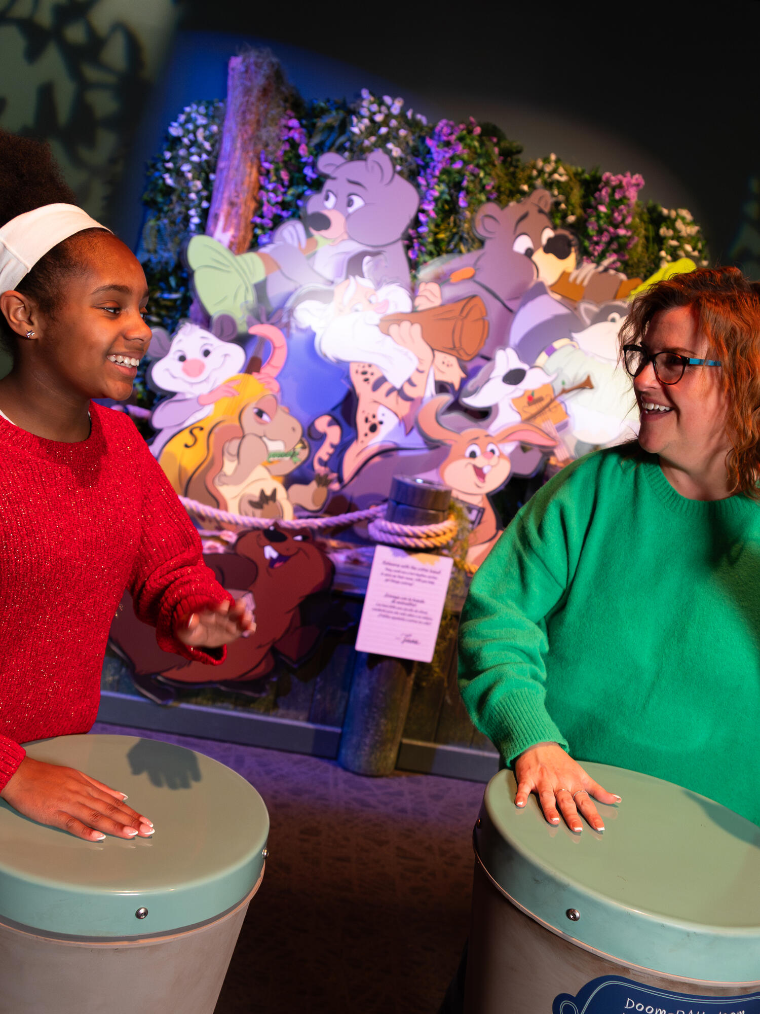 Child and grown-up playing drums.