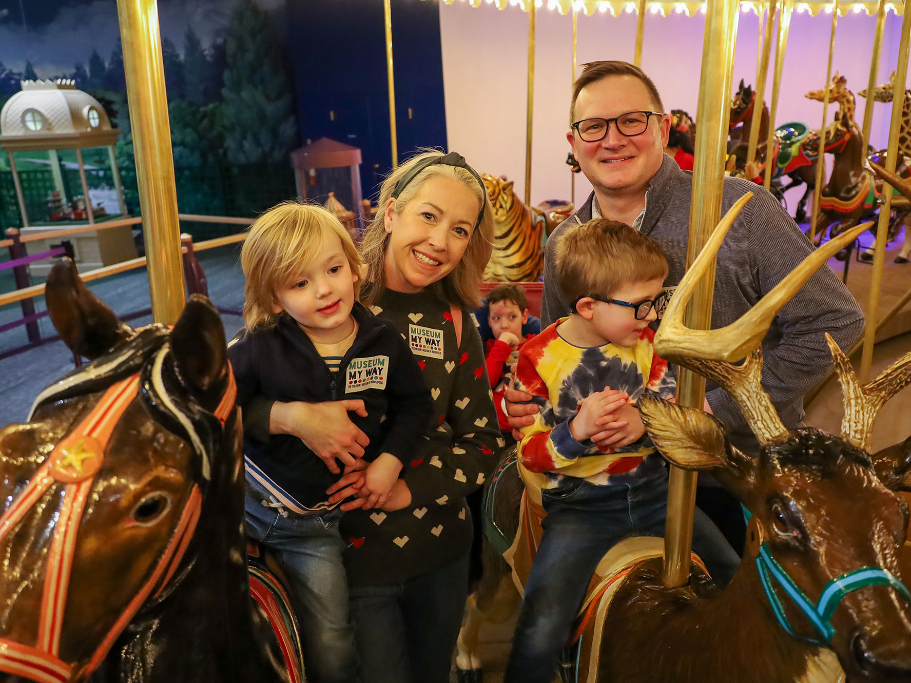 Family riding the Carousel.