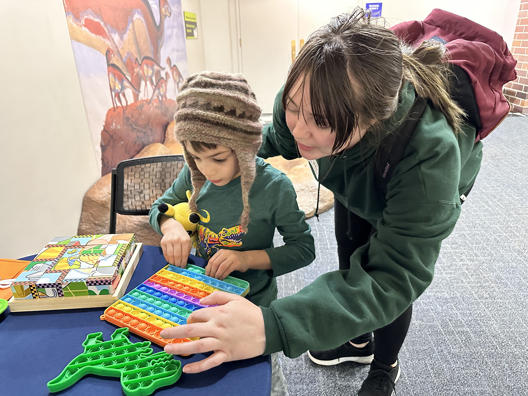 Grown-up and child using fidgets.