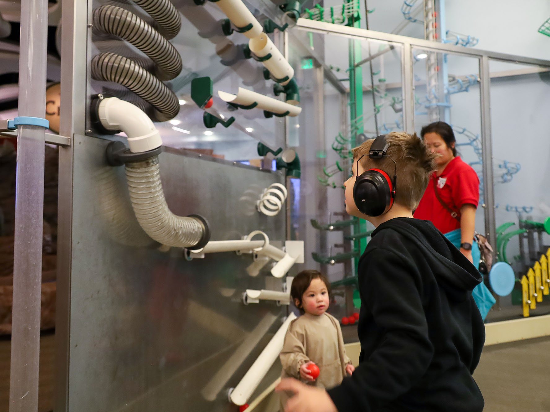 Person wearing noise-caneceling headphones in an exhibit.