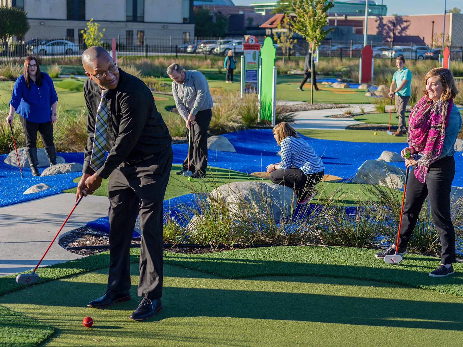 Adults putting in Golf exhibit. 