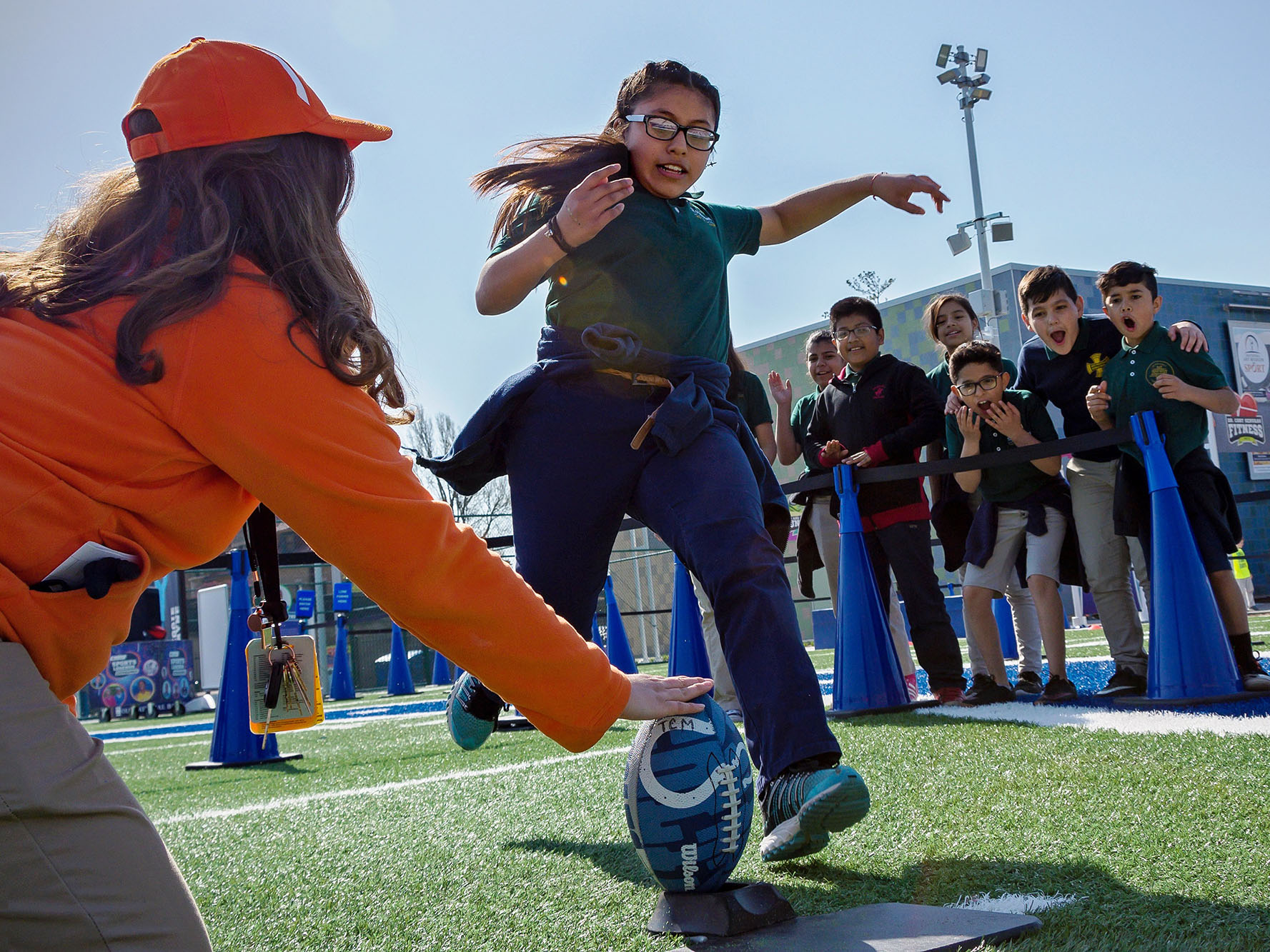 Child kicking a football.