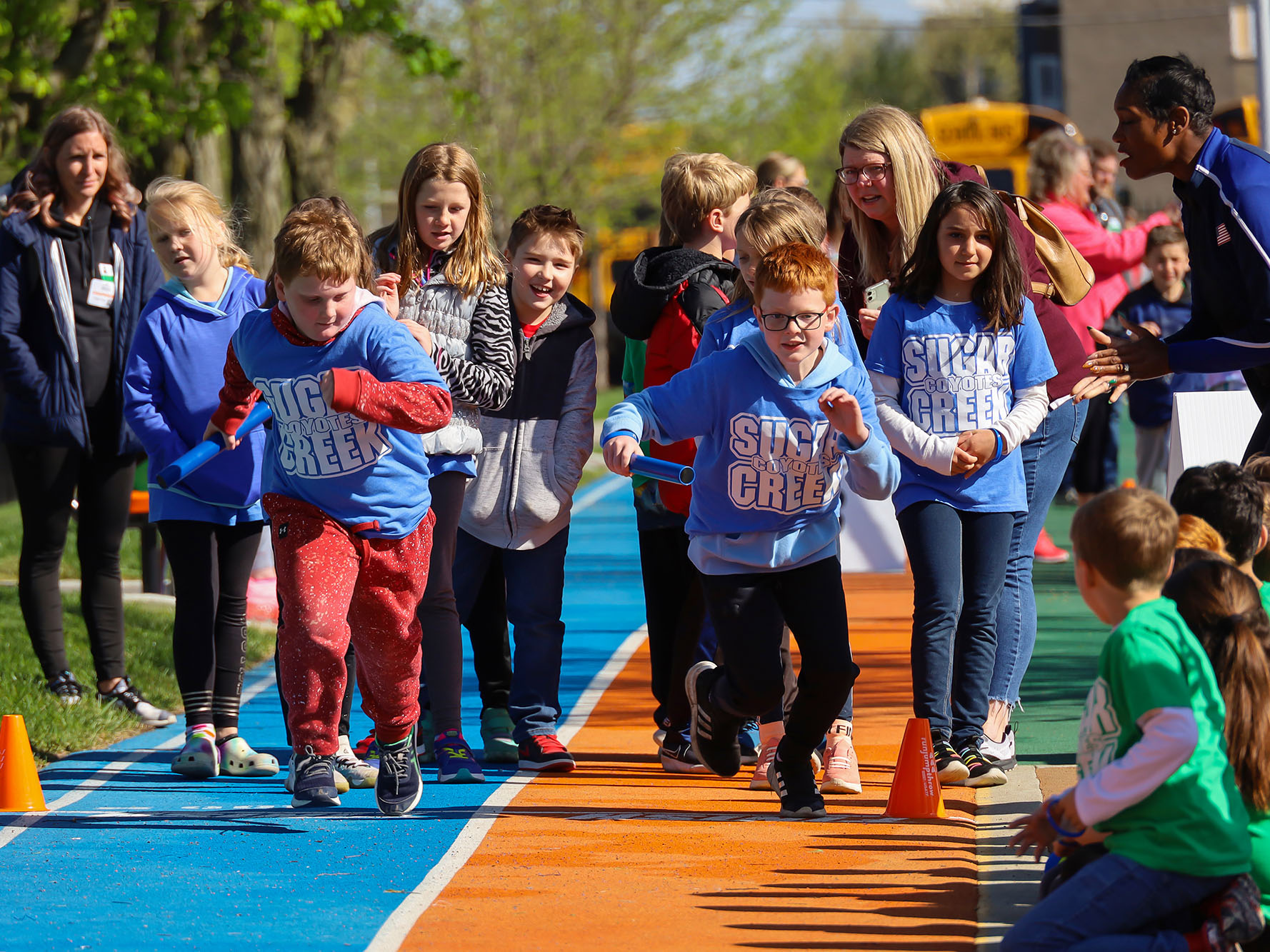 Children running on a track.