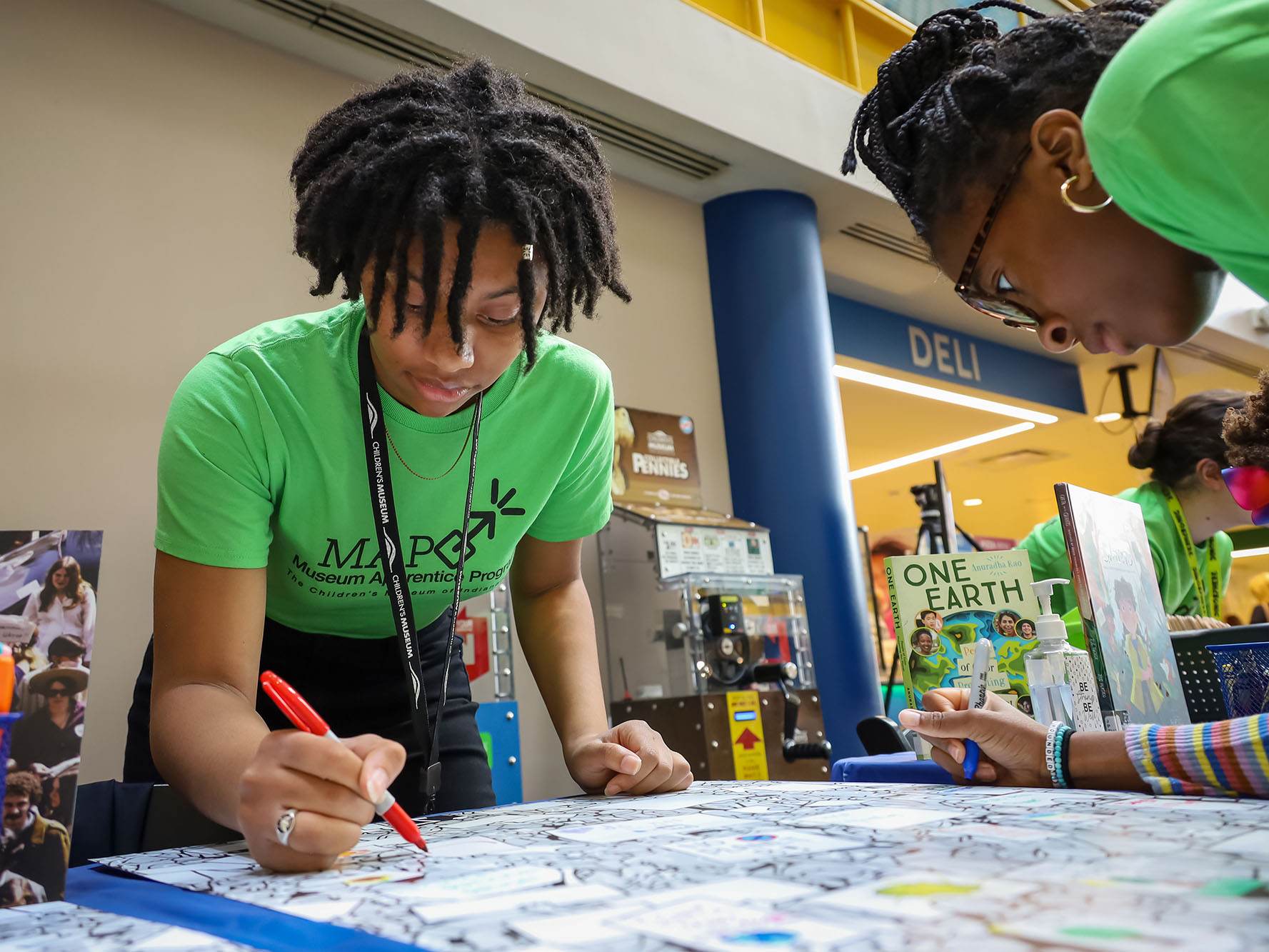 Museum Apprentice Program participant leading a tabletop activity.