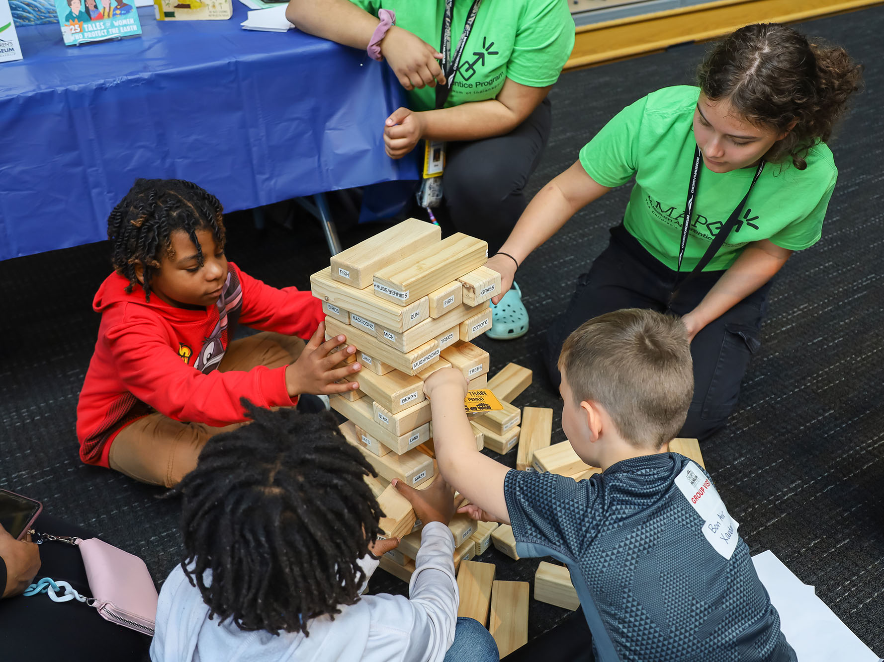 Museum Apprentice Program participant leading a game of giant Jenga.