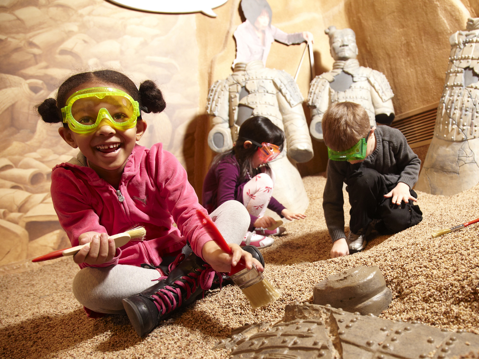 Children playing in pretend dig pit.